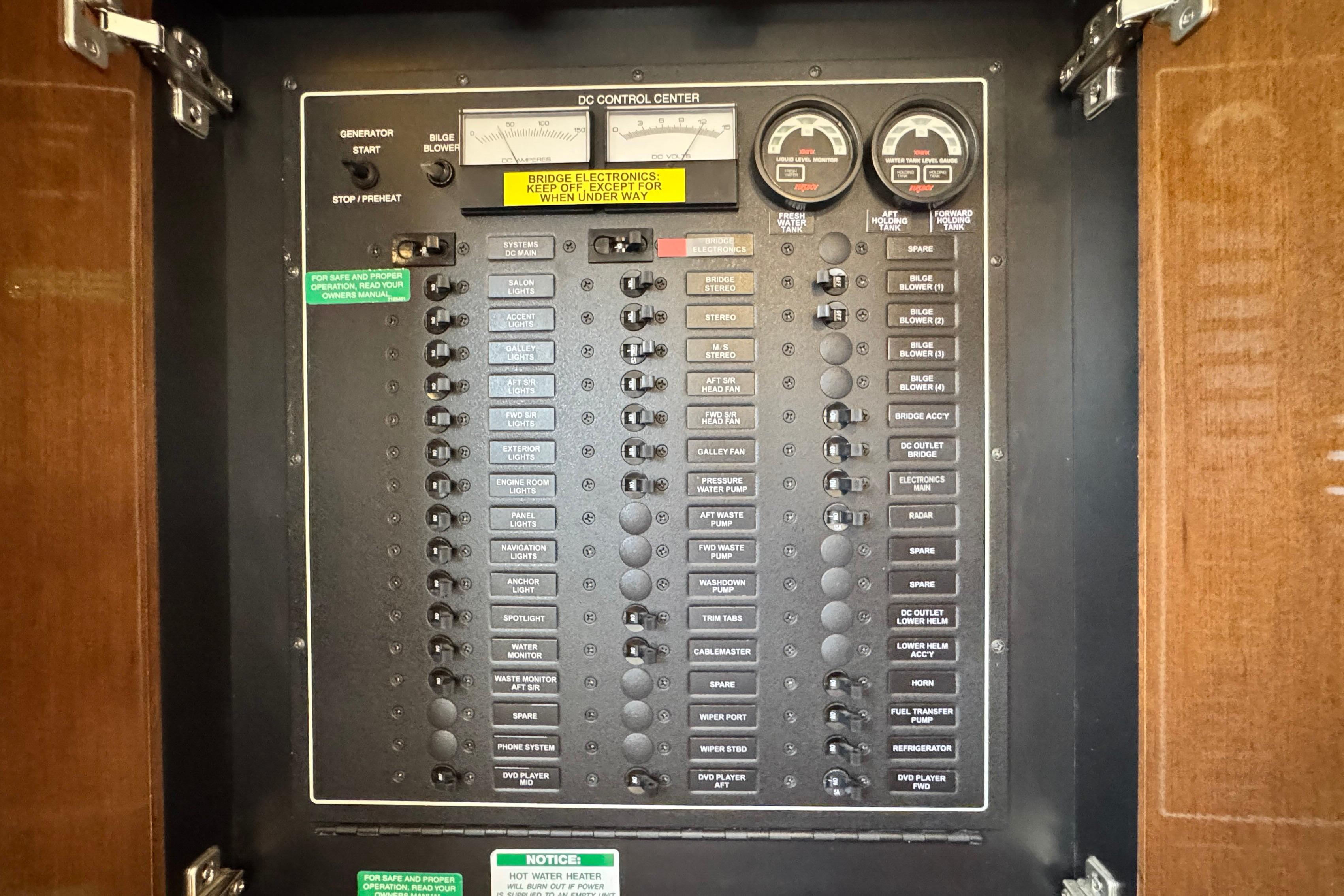 Electrical control panel on a 2007 Carver 47 Motor Yacht, featuring various switches and gauges.