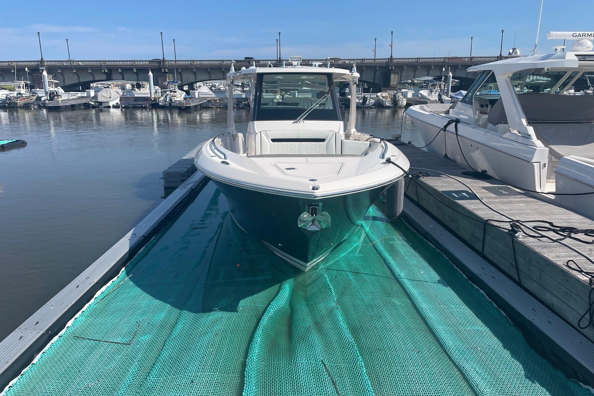 2024 Tiara Yachts 34 LS docked at marina, showcasing sleek design and modern features.