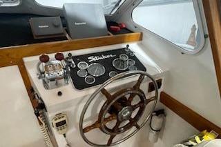 1964 Striker Model 120 boat helm with classic wooden steering wheel and instrument panel.
