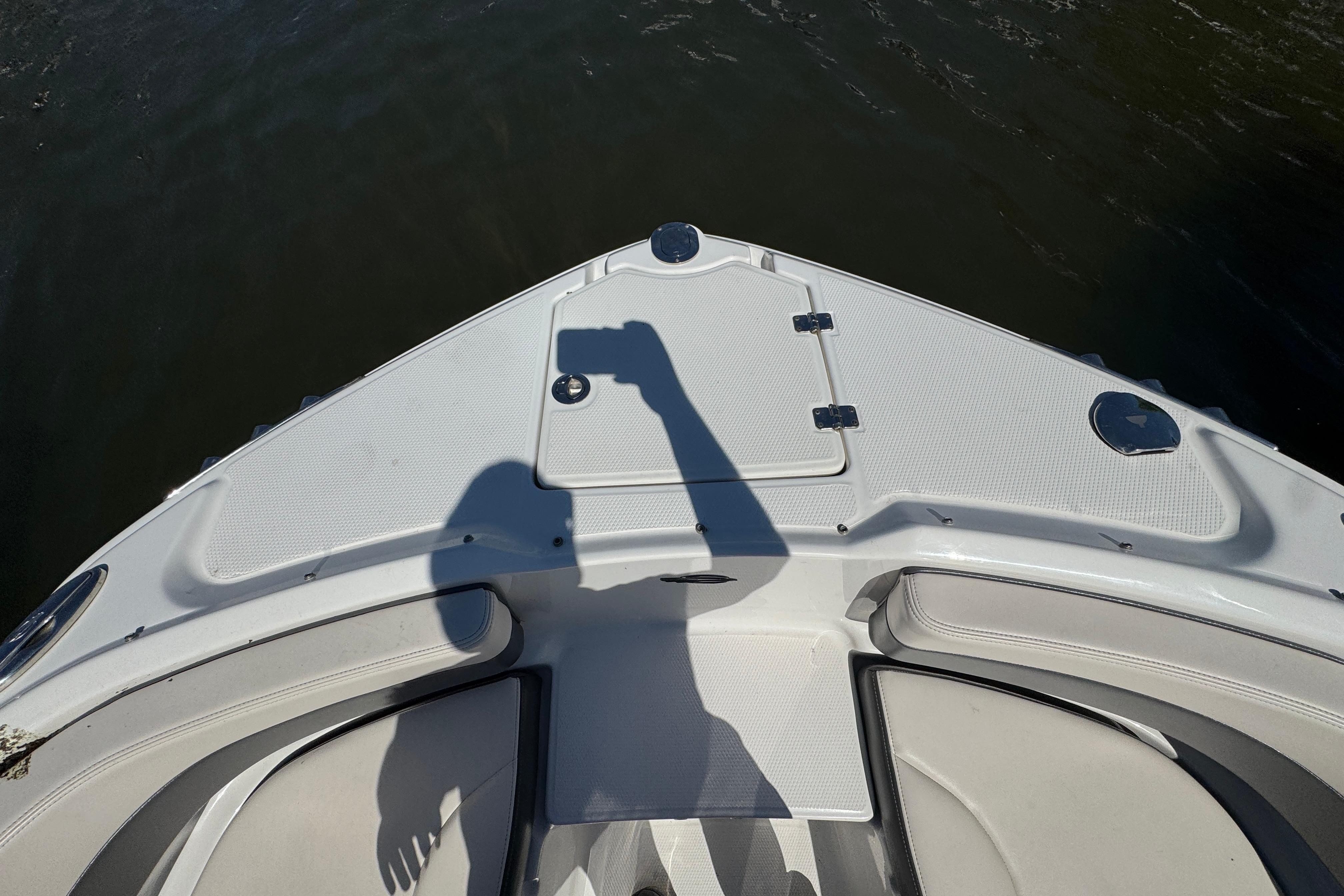 Bow view of 2018 Chaparral 250 Suncoast boat with shadow on deck.