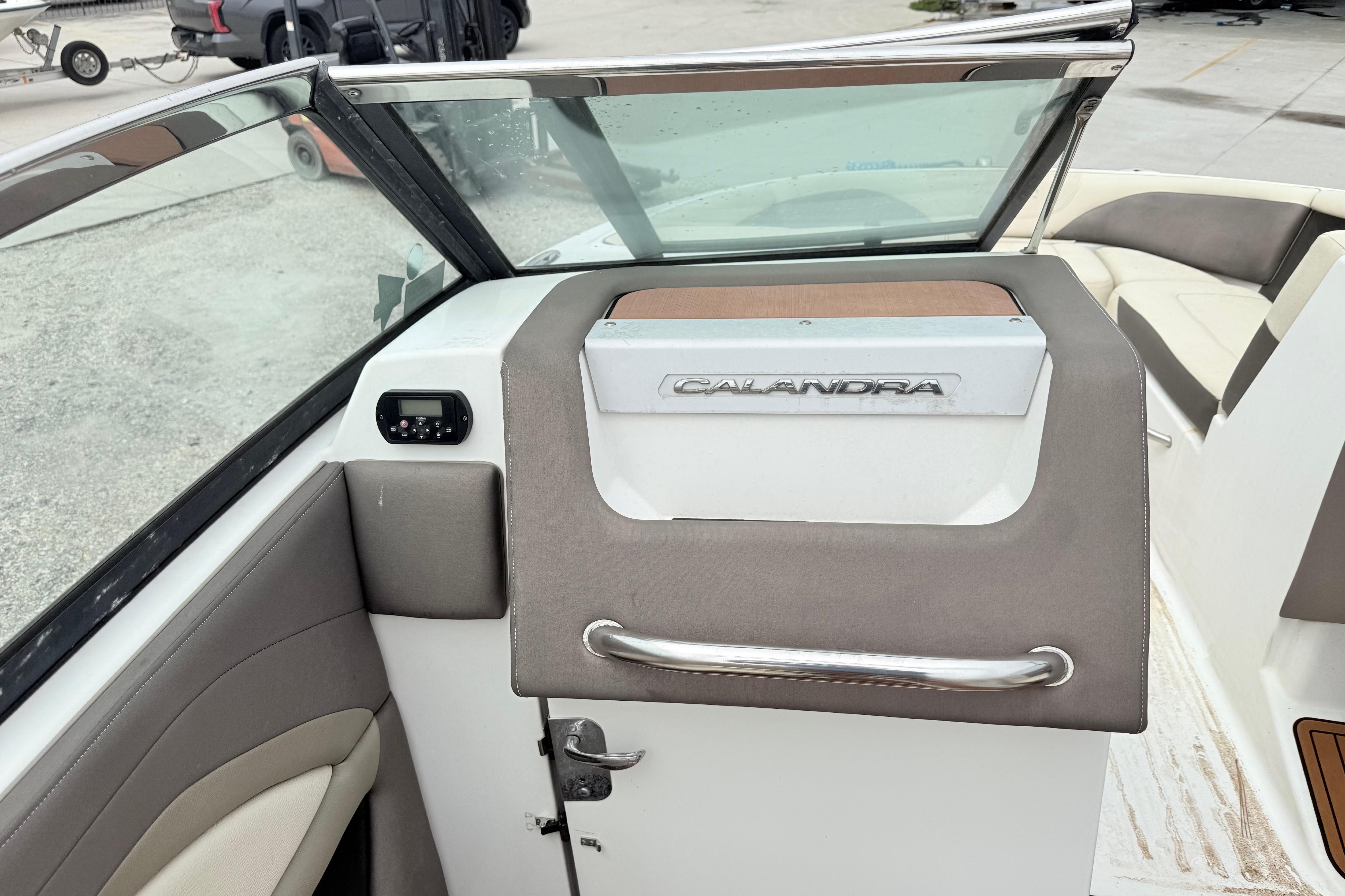 2018 Bryant Calandra boat interior with windshield and seating area.