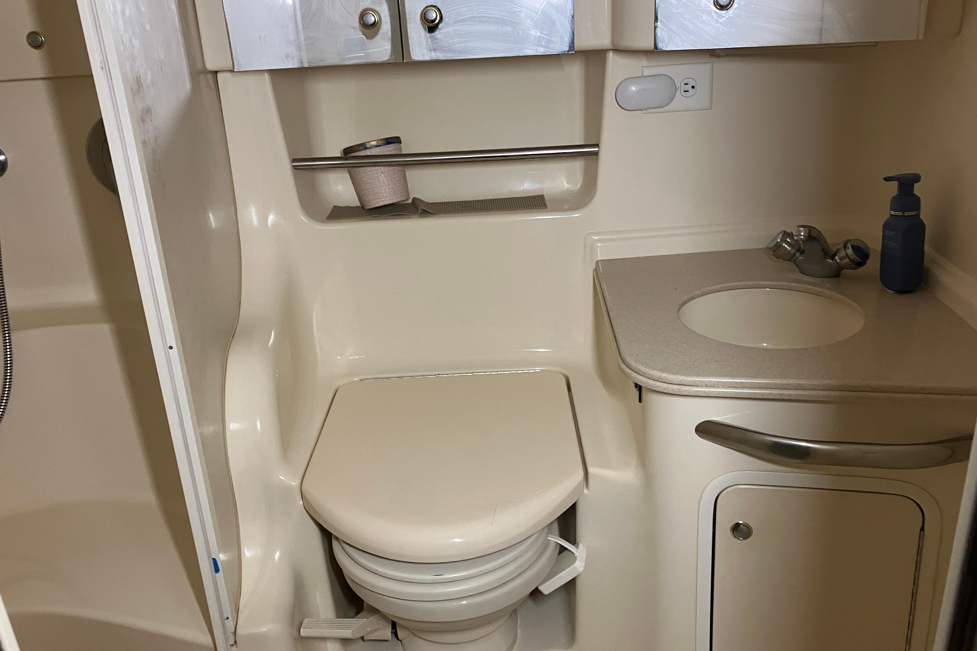 Bathroom interior of 2002 Sea Ray 410 Sundancer yacht, featuring toilet and sink.