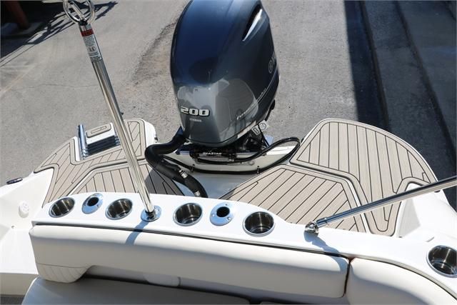 The image shows the stern of a Stingray 212 SC boat with an outboard motor.