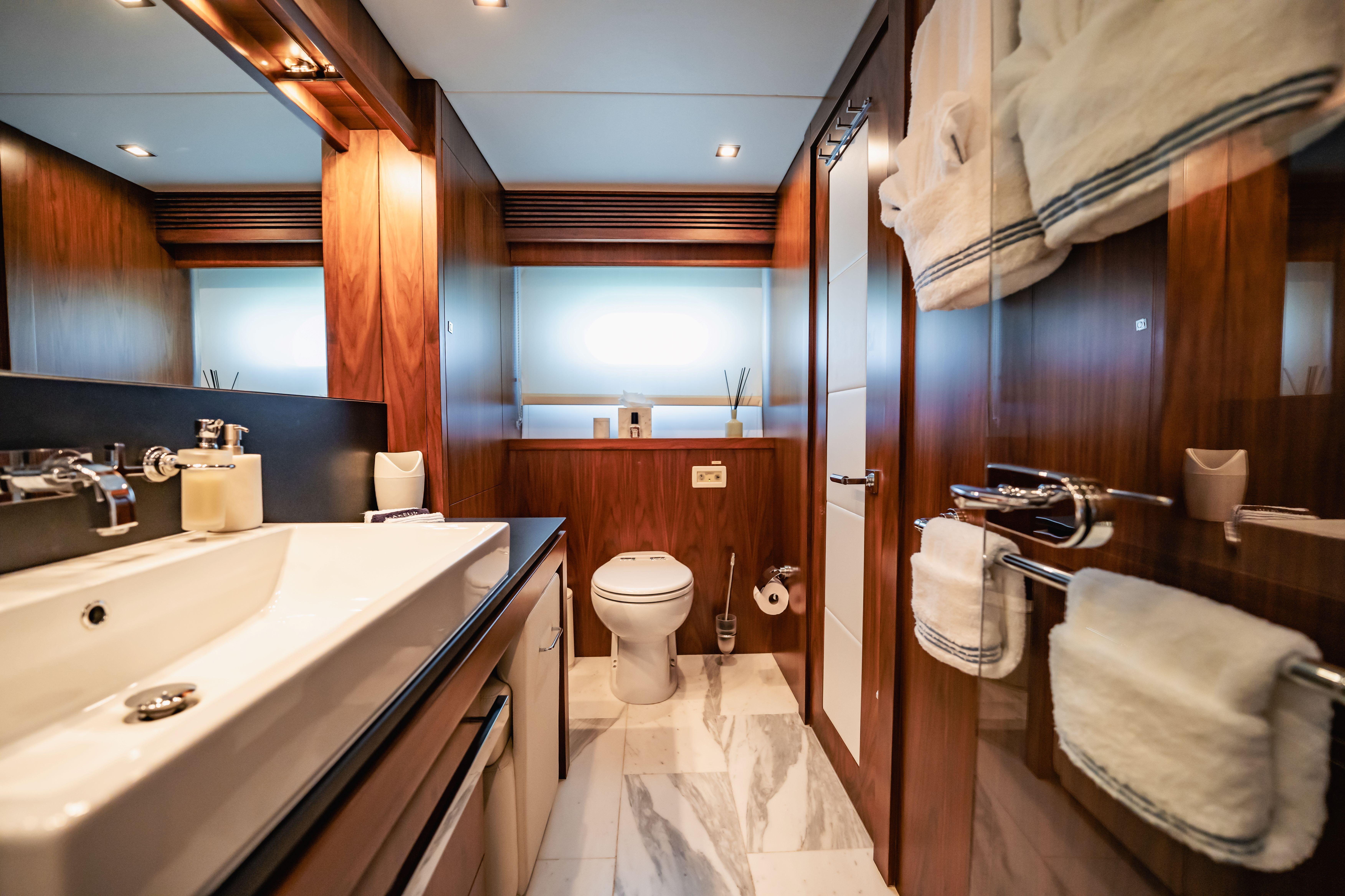 Luxurious bathroom on 2011 Sunseeker 34 Metre Yacht with elegant wood finishes.
