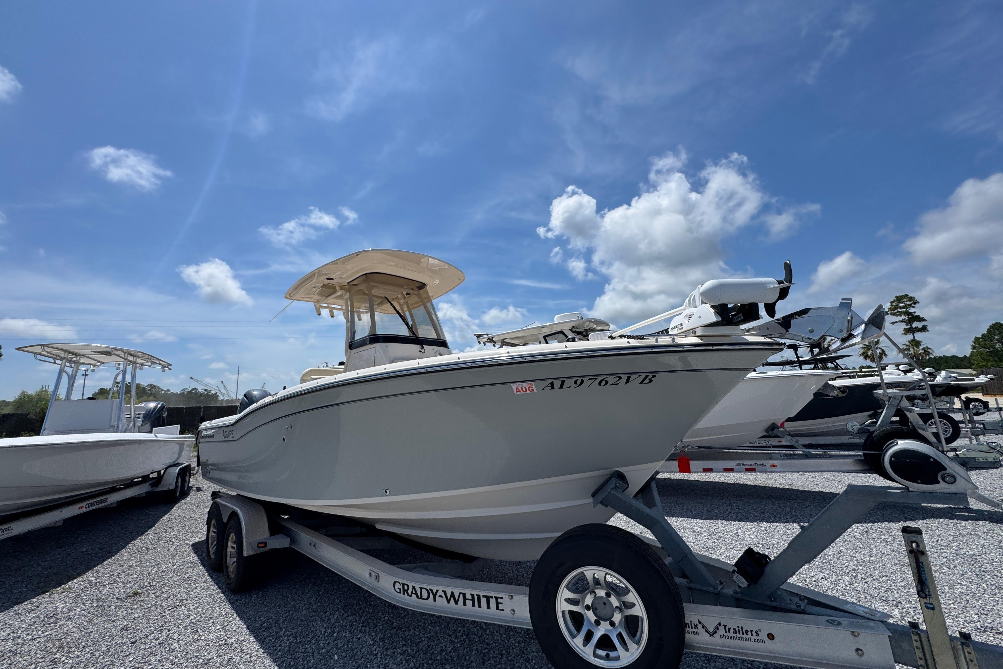 2022 Grady-White Fisherman 257 boat on trailer under clear blue sky.