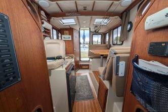 Interior of 2008 Ranger 25 featuring wood paneling and seating area.