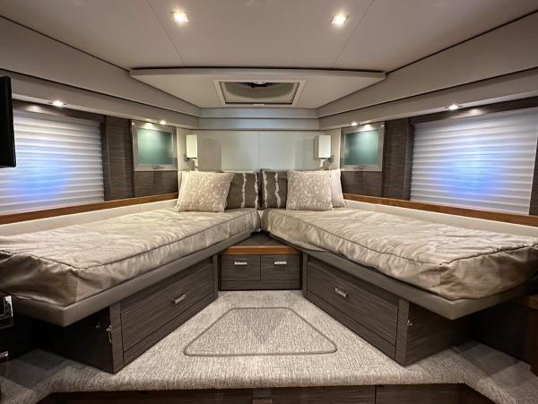 Luxurious 2019 Tiara Yachts C53 cabin with twin beds and modern decor.