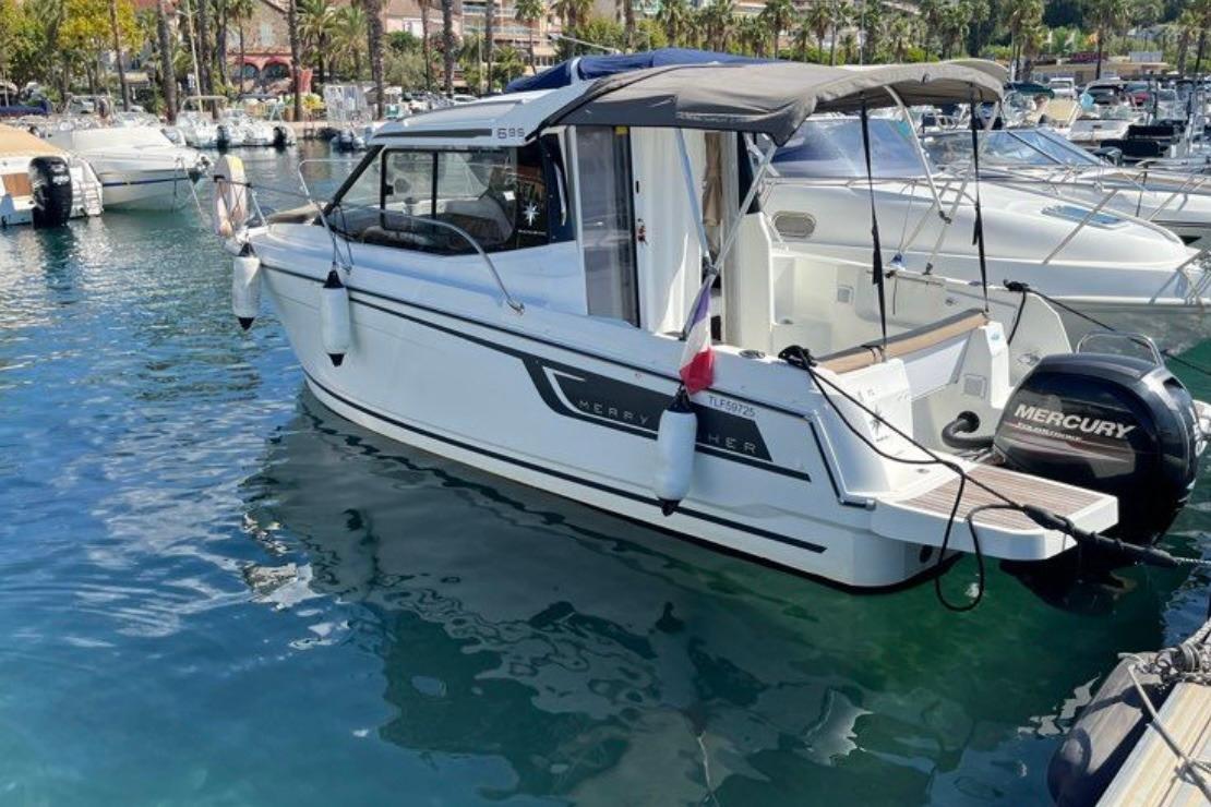 2017 Jeanneau Merry Fisher 695 boat docked in a marina with a Mercury outboard motor.