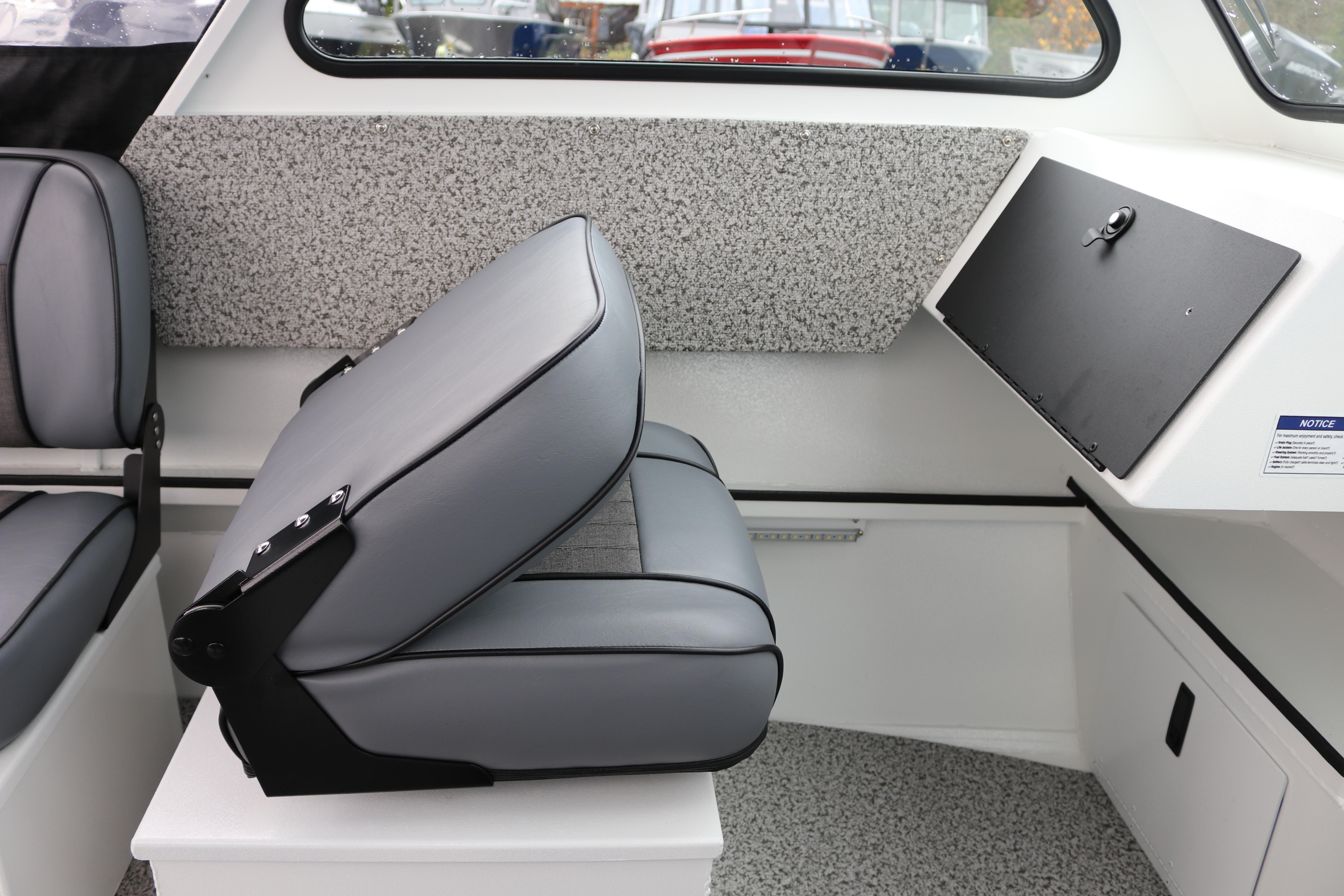 Interior of 2026 Alumaweld Stryker 202 boat with gray seating and storage compartment.
