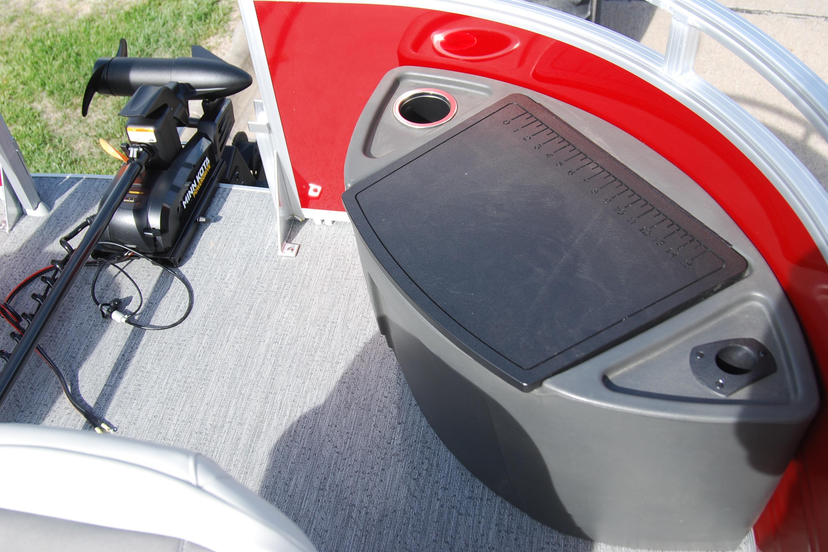 2026 Sun Tracker Fishin' Barge 22 XP3 deck with trolling motor and storage compartment.