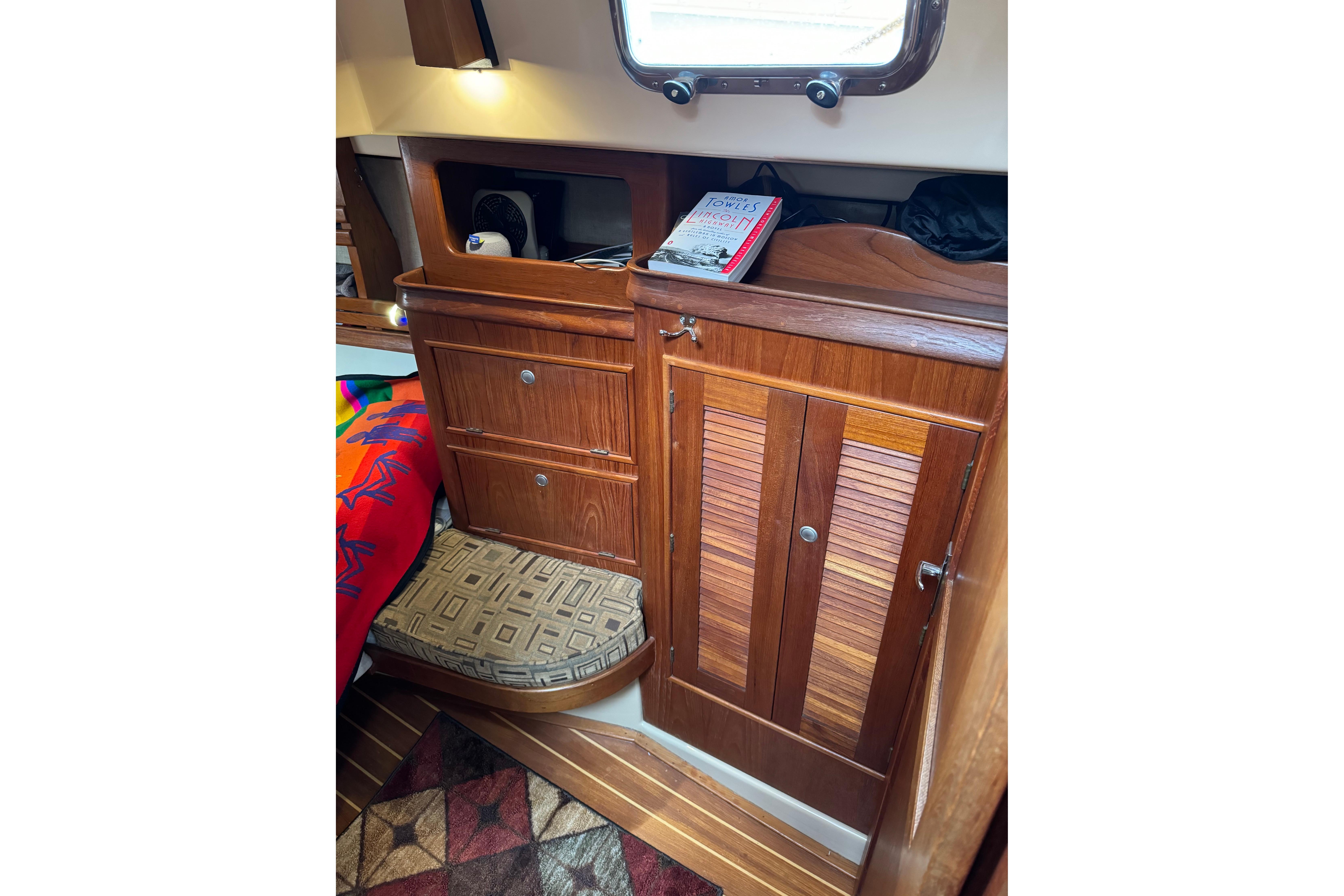 1997 Island Packet 37 interior with wooden cabinets and cozy decor.