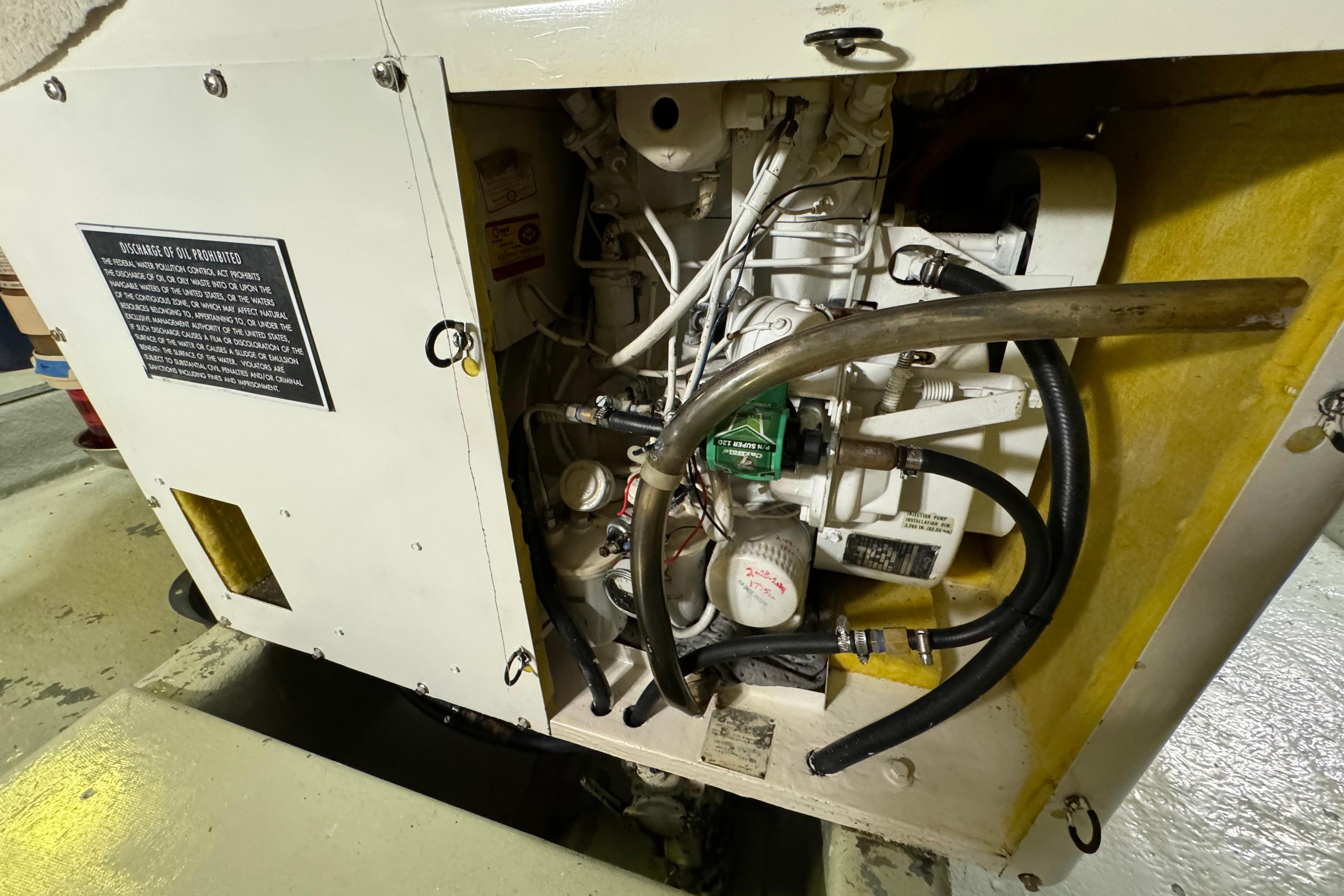 Engine compartment of a 1978 Californian 42 LRC boat, showing mechanical components and hoses.