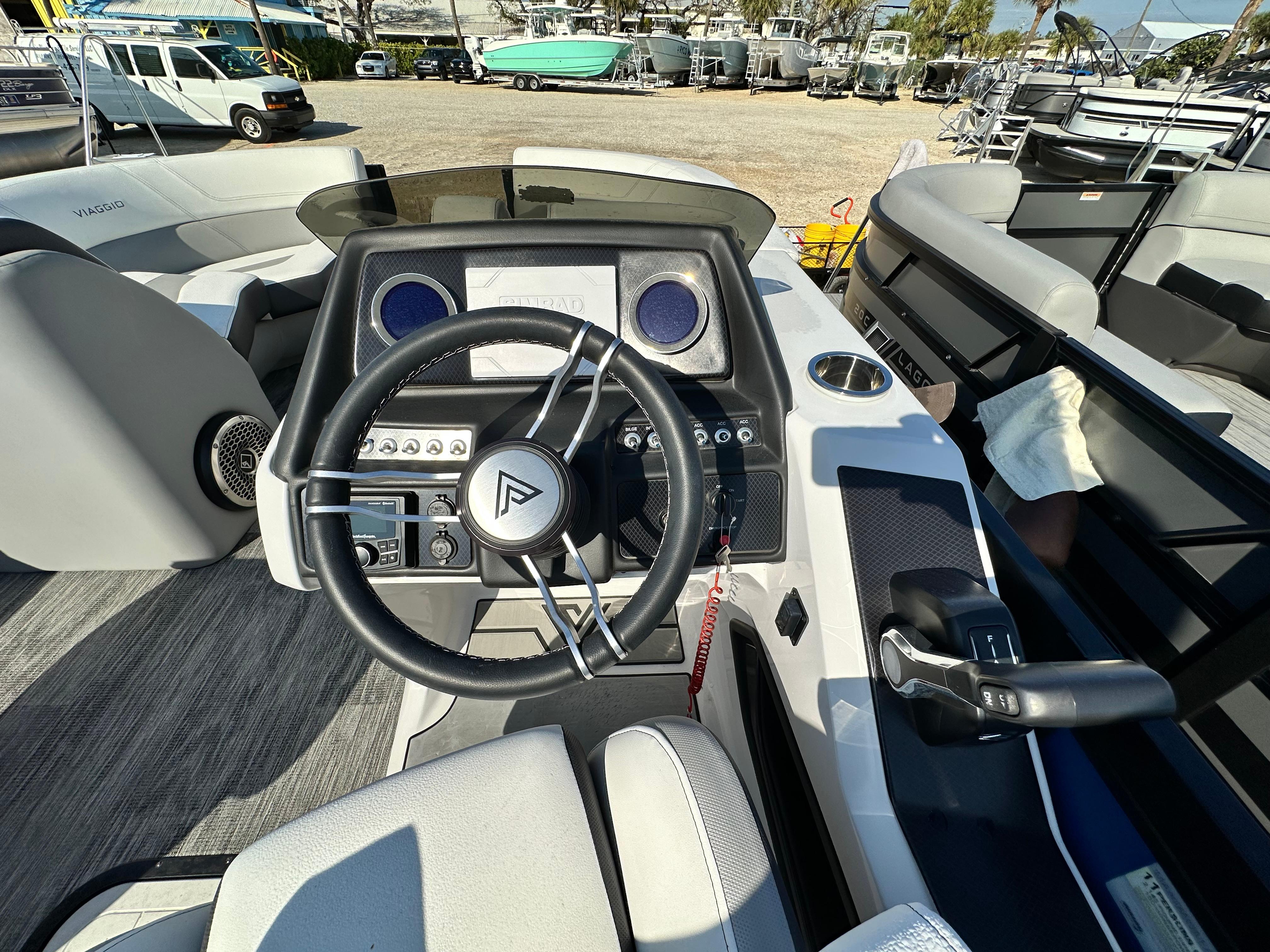 Cockpit of 2022 Viaggio Diamante 21S boat with steering wheel and control panel.