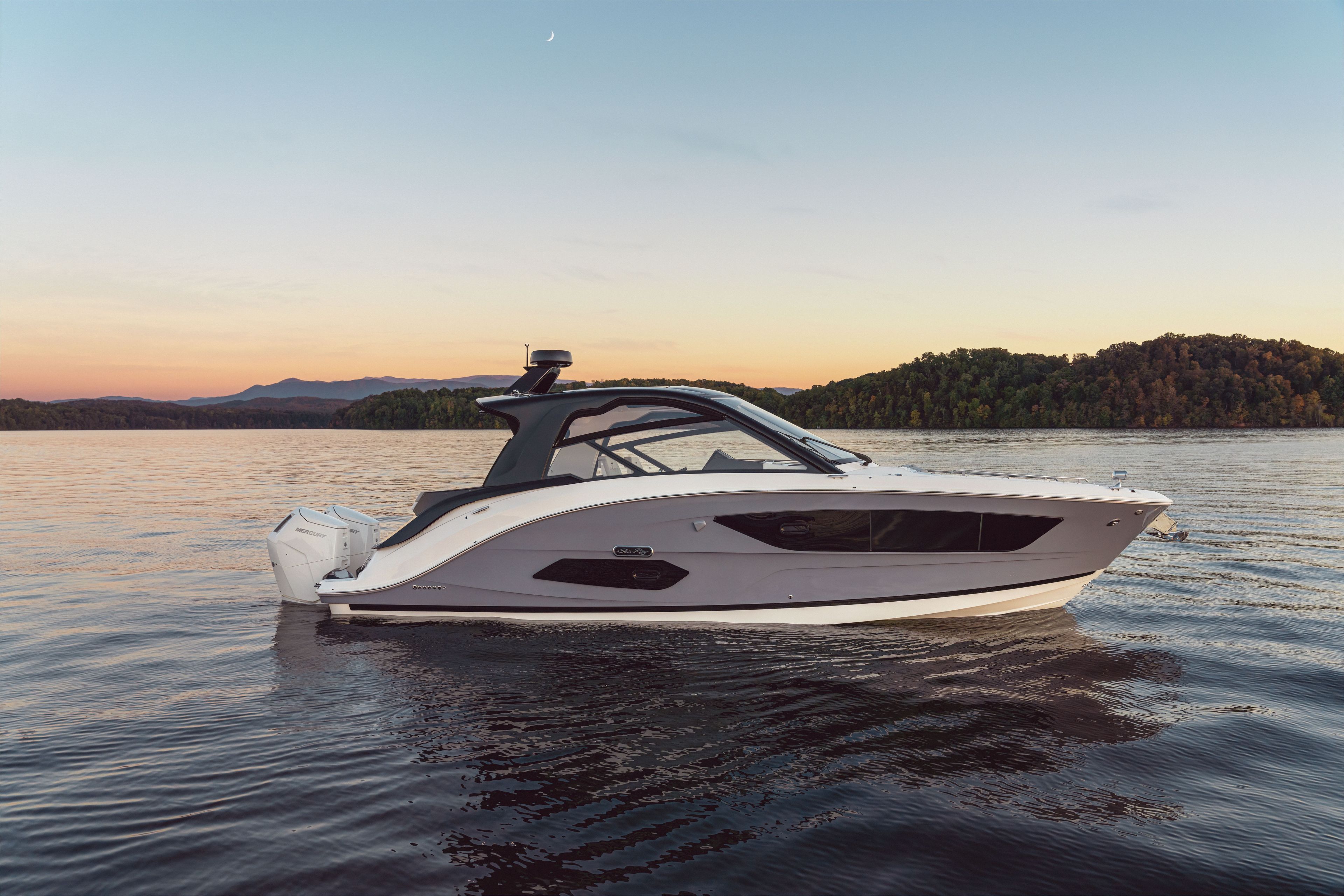 2026 Sea Ray Sundancer 370 Outboard on calm water at sunset.