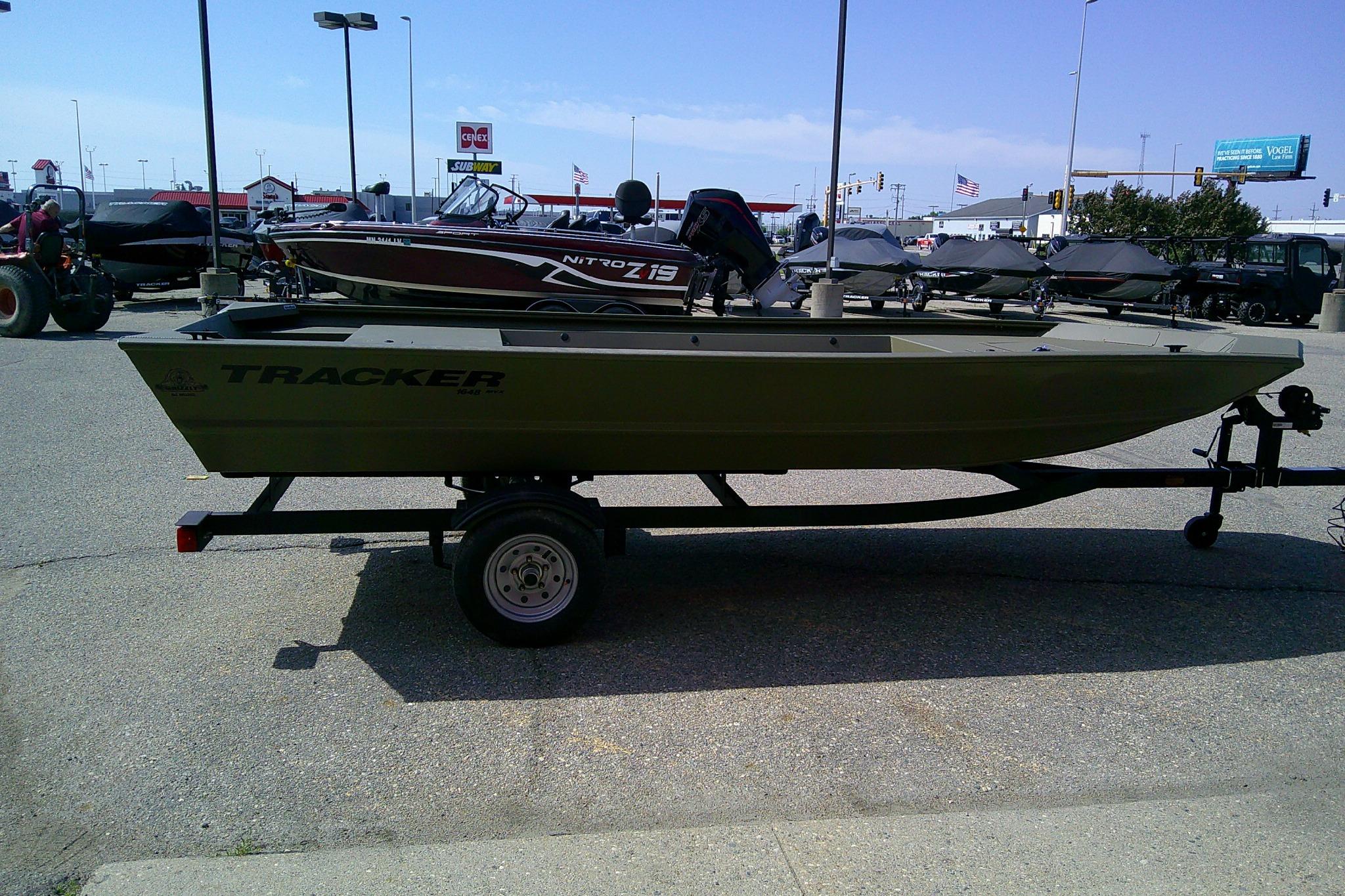 2026 Tracker Grizzly 1648 Utility boat on trailer in outdoor dealership lot.