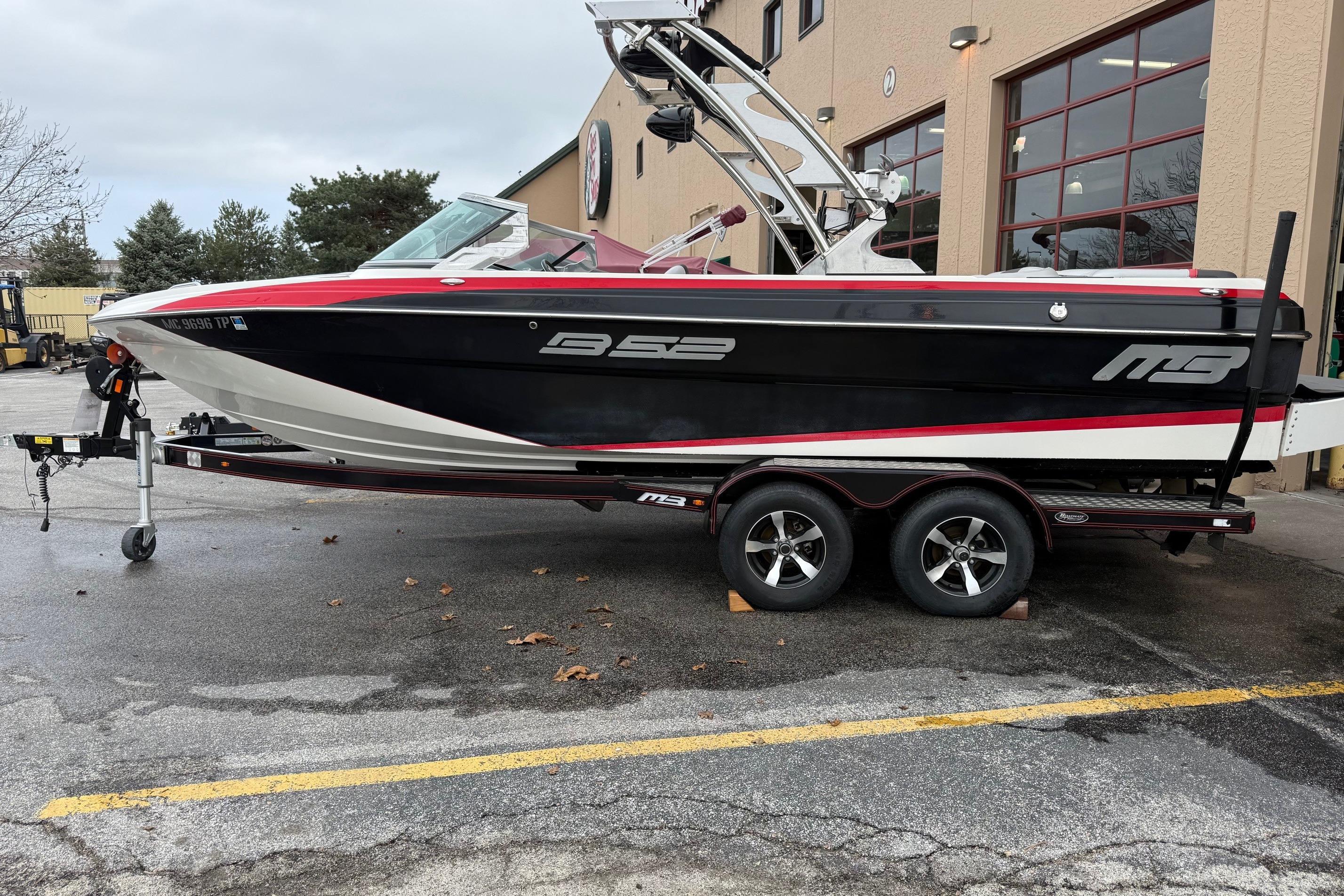 2014 MBSPORTS B523 23V boat on trailer outside a building.