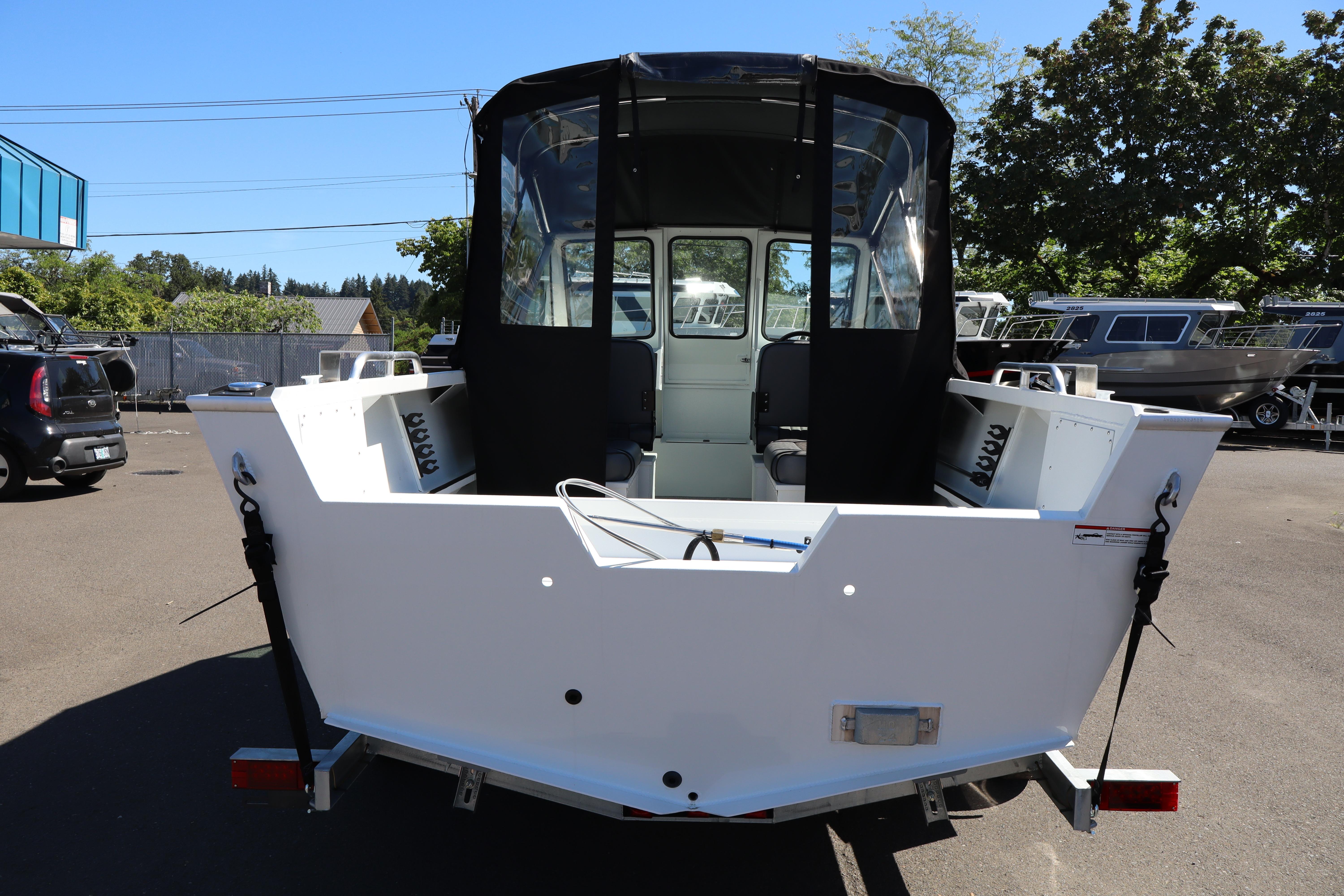 2026 Alumaweld Stryker 202 boat, rear view, parked outdoors on a sunny day.