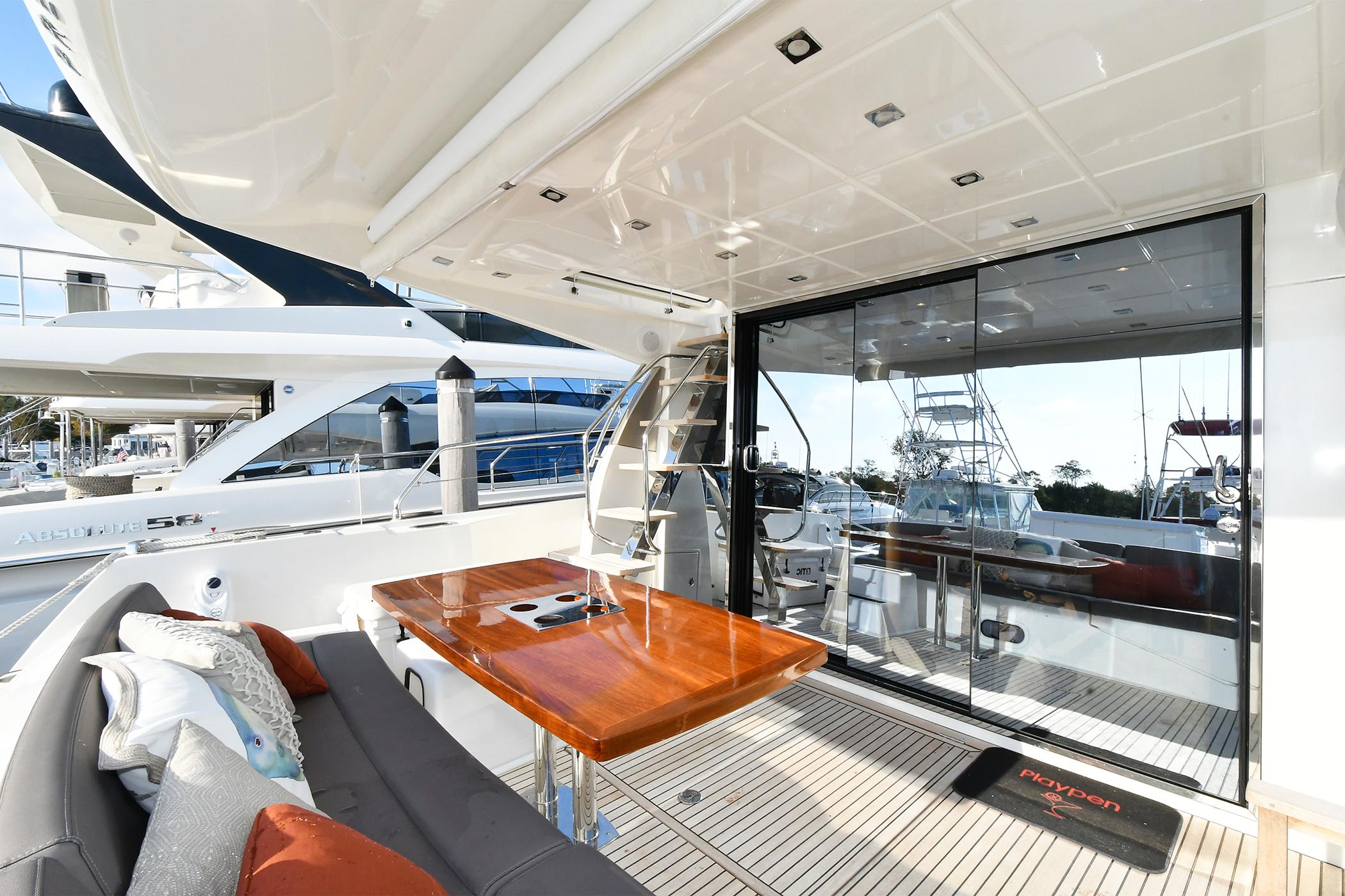 Luxury yacht deck with seating and table, Prestige 560 Fly, 2018 model.