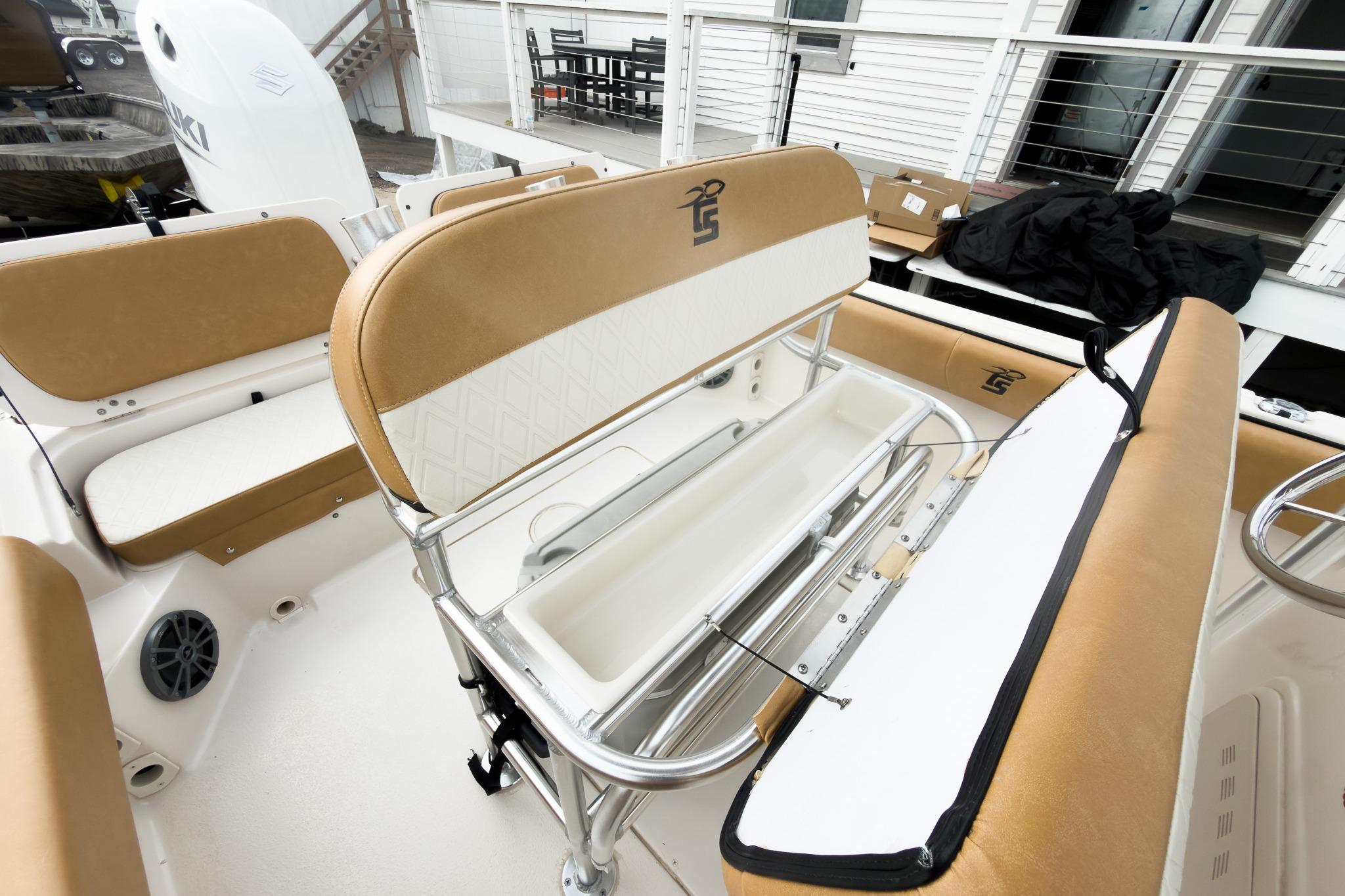 2025 Carolina Skiff 21 Ultra Elite boat interior with tan seating and storage compartments.