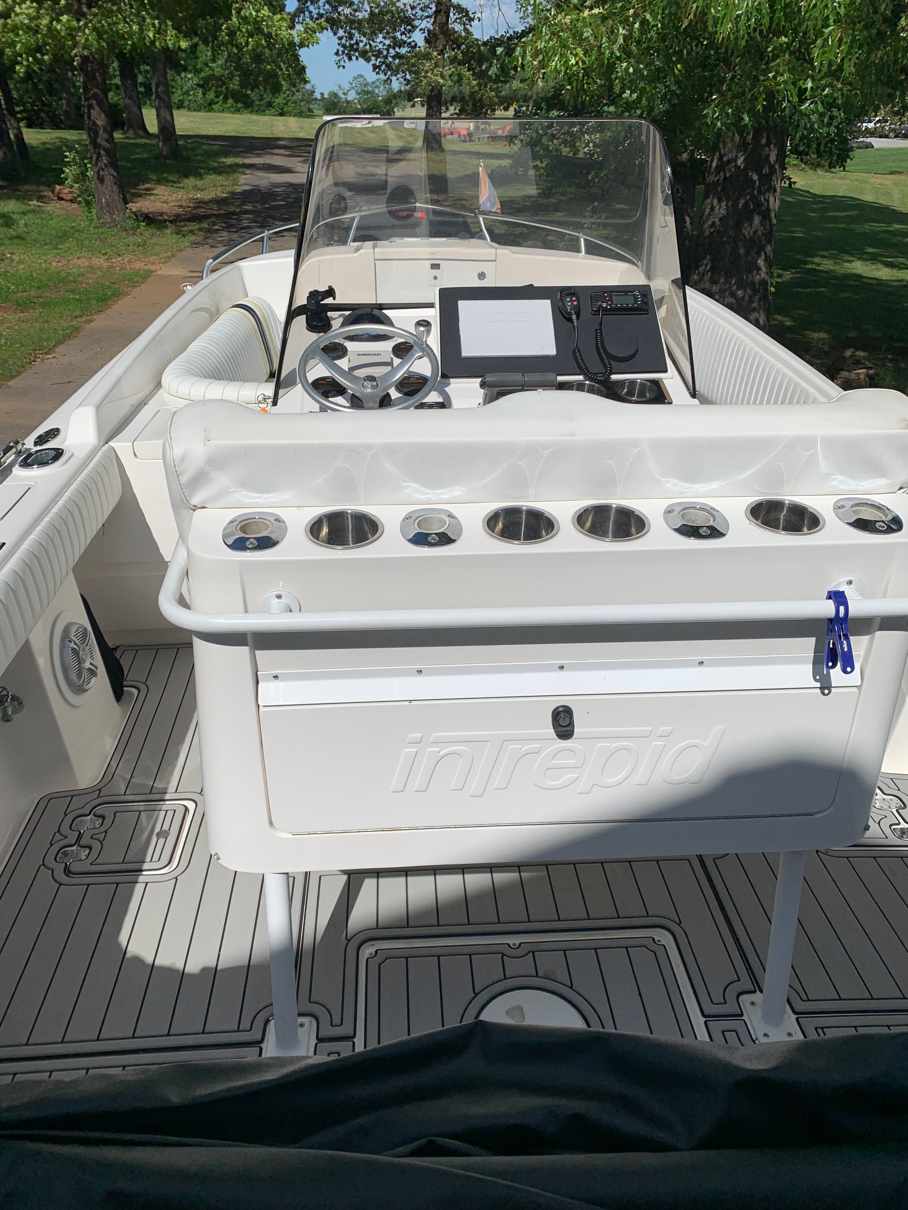 Intrepid 322 Cuddy Center Console boat, 2002 model, on a sunny deck.