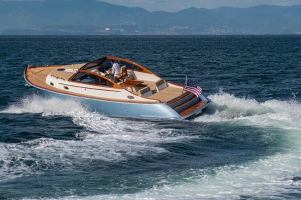 Vento V40 Retro Classic Open 2023 yacht cruising on the ocean with mountains in the background.