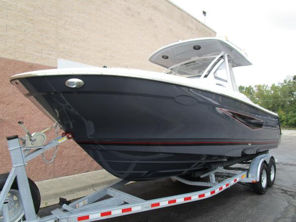 2025 Solara S-250 CW boat on trailer, sleek design, parked outdoors.