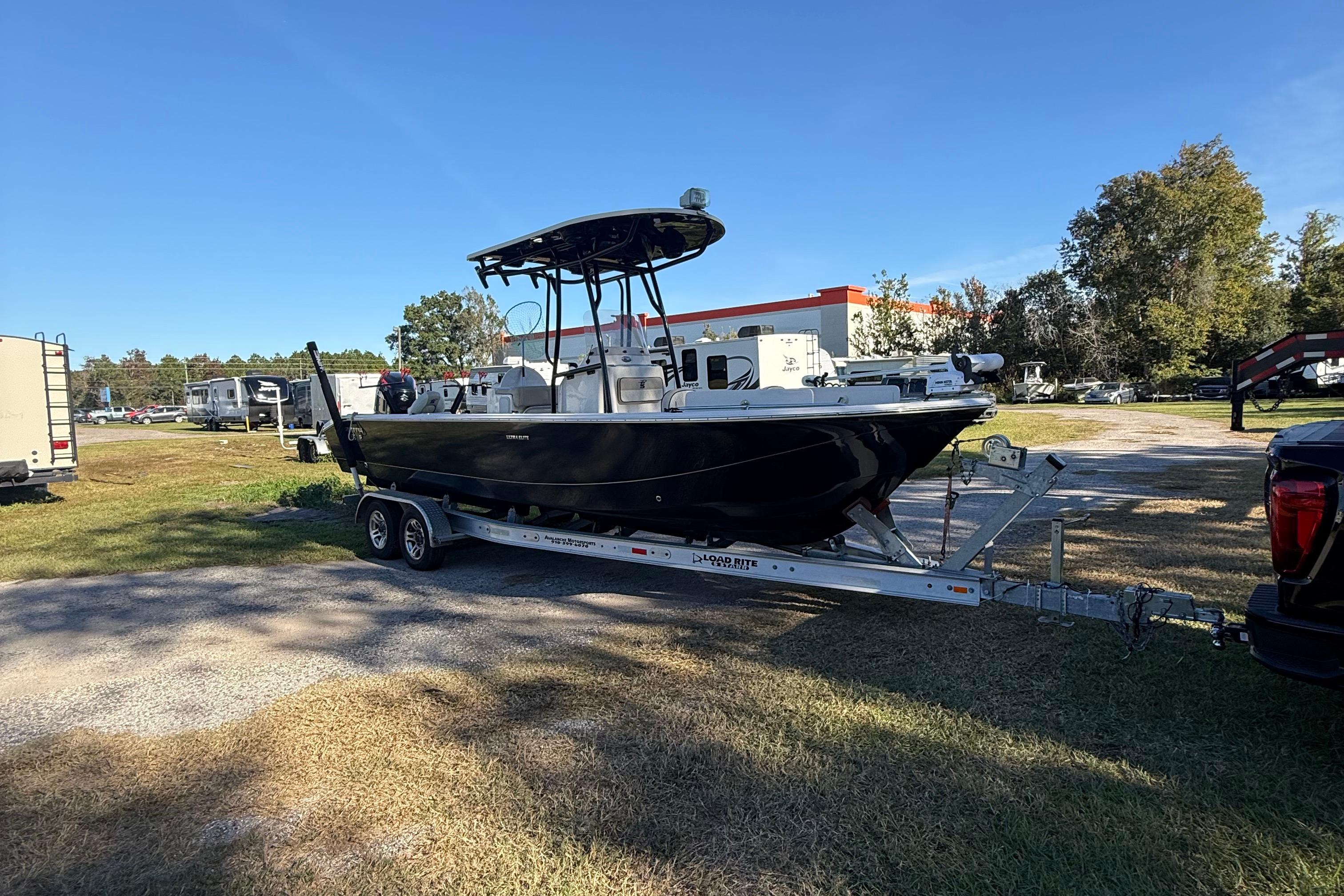 2021 Carolina Skiff 26 Ultra Elite boat on trailer in outdoor setting.