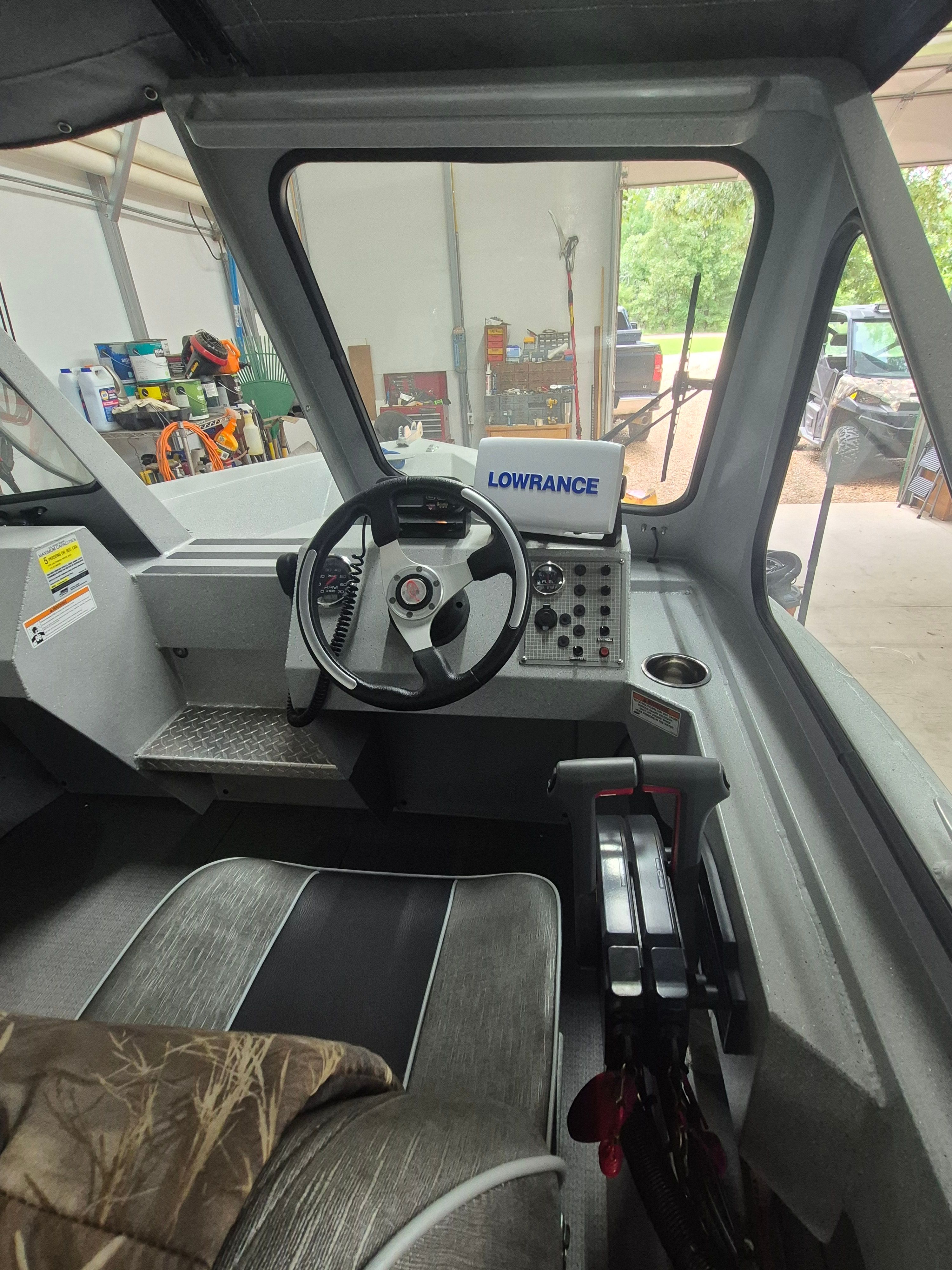 Interior of a 2016 Duckworth 18 Advantage boat with steering wheel and electronics.