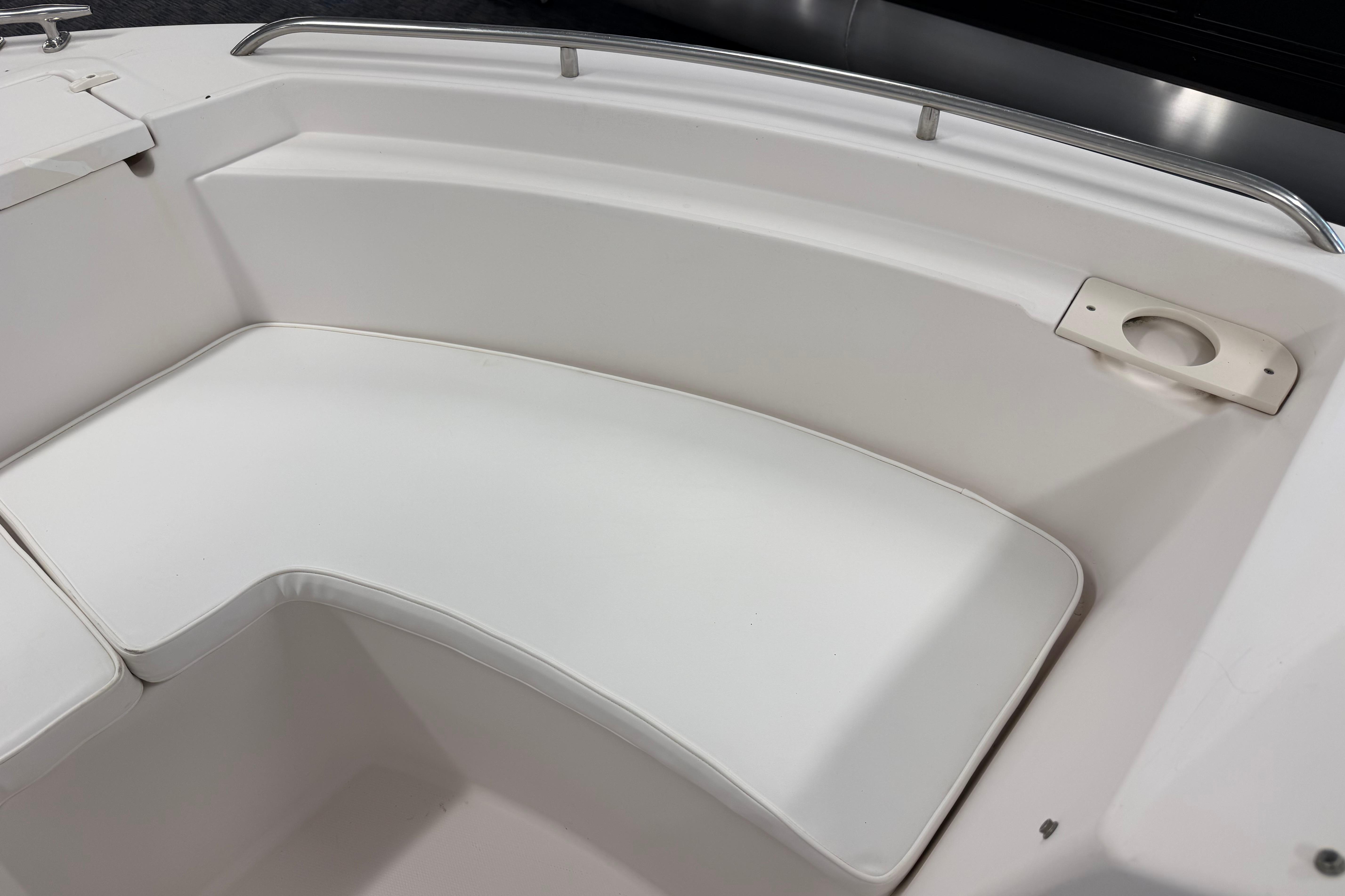 2001 Grady-White Tournament 223 boat interior seating area with white cushions.