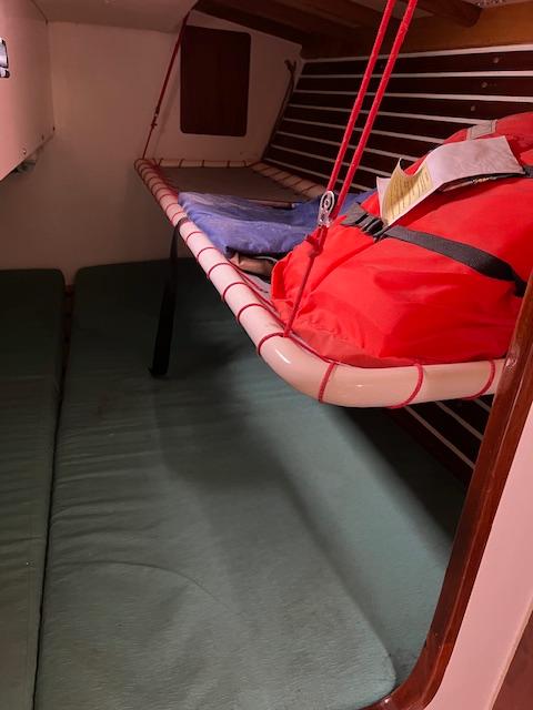 Interior of 2003 Custom 38 C/R boat with bunk beds and life jacket.
