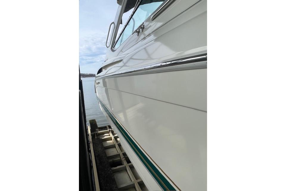 1999 Formula 400 Super Sport boat docked, showcasing sleek white hull and chrome accents.