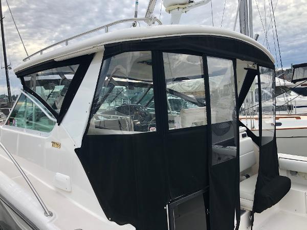 2003 Tiara Yachts 3500 Open with black canvas enclosure at marina.