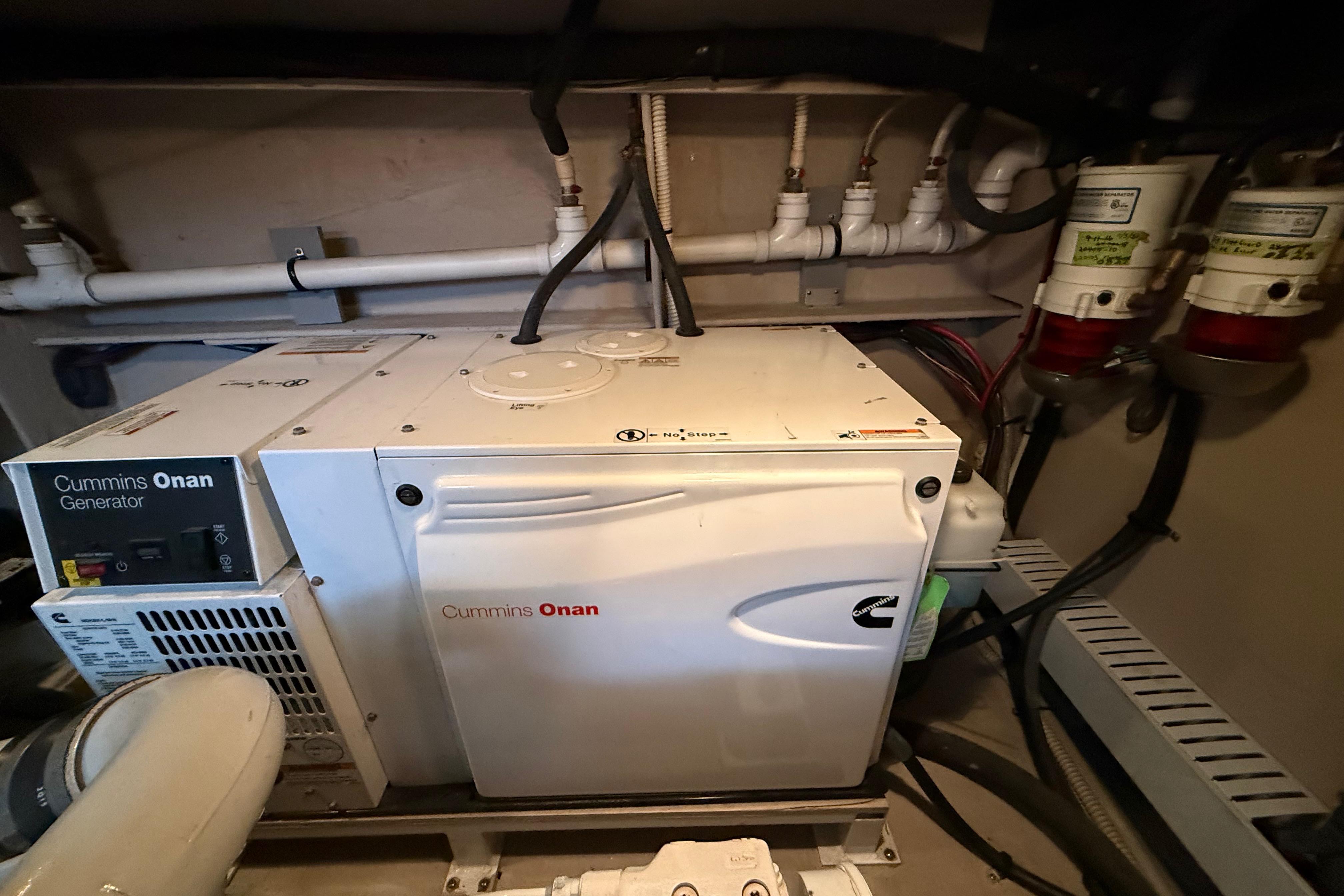 Cummins Onan generator in 2016 Sea Ray Sundancer 510 engine room, showcasing marine equipment.