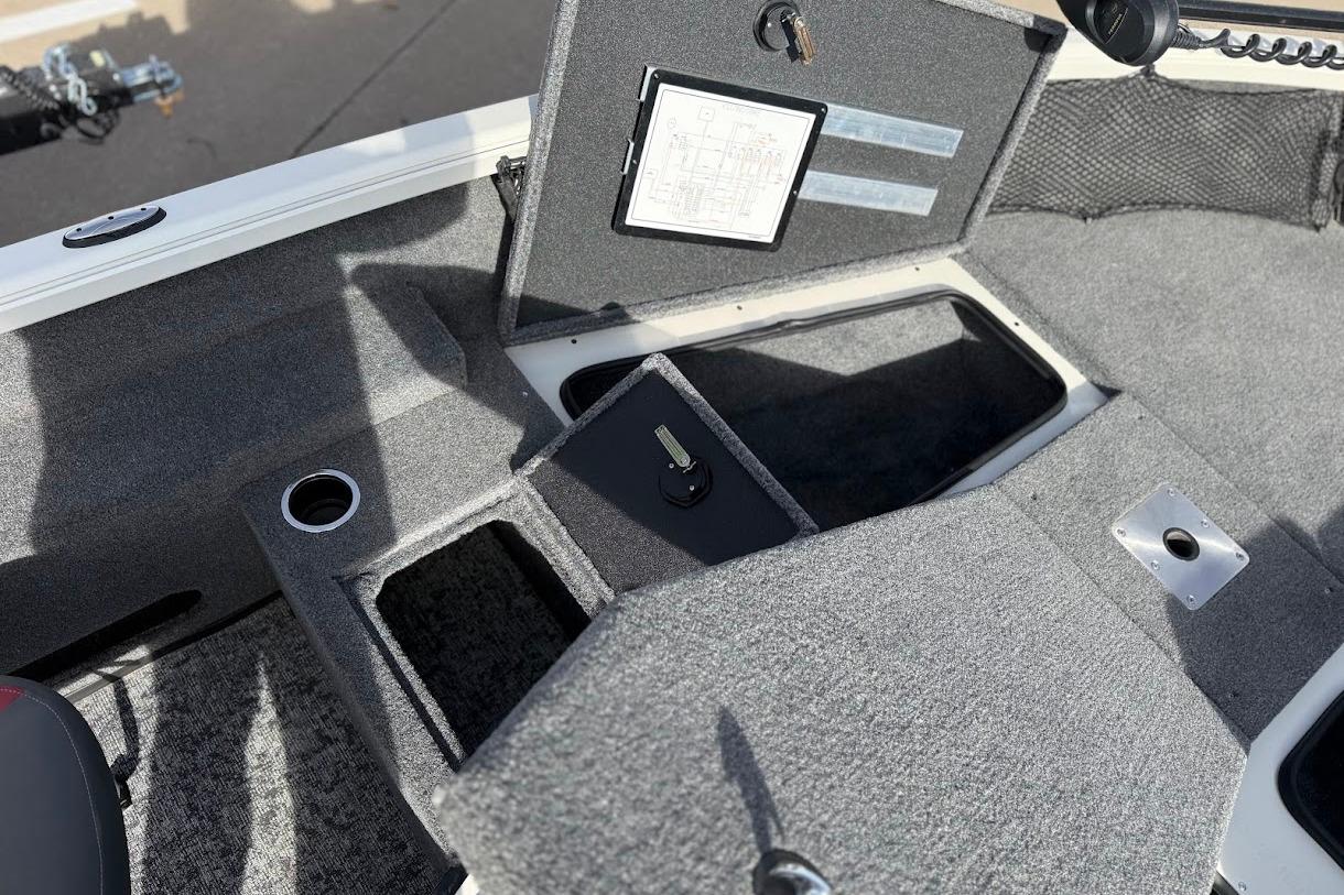 2026 Ranger VS1882SC Reata boat interior with storage compartments and carpeted flooring.