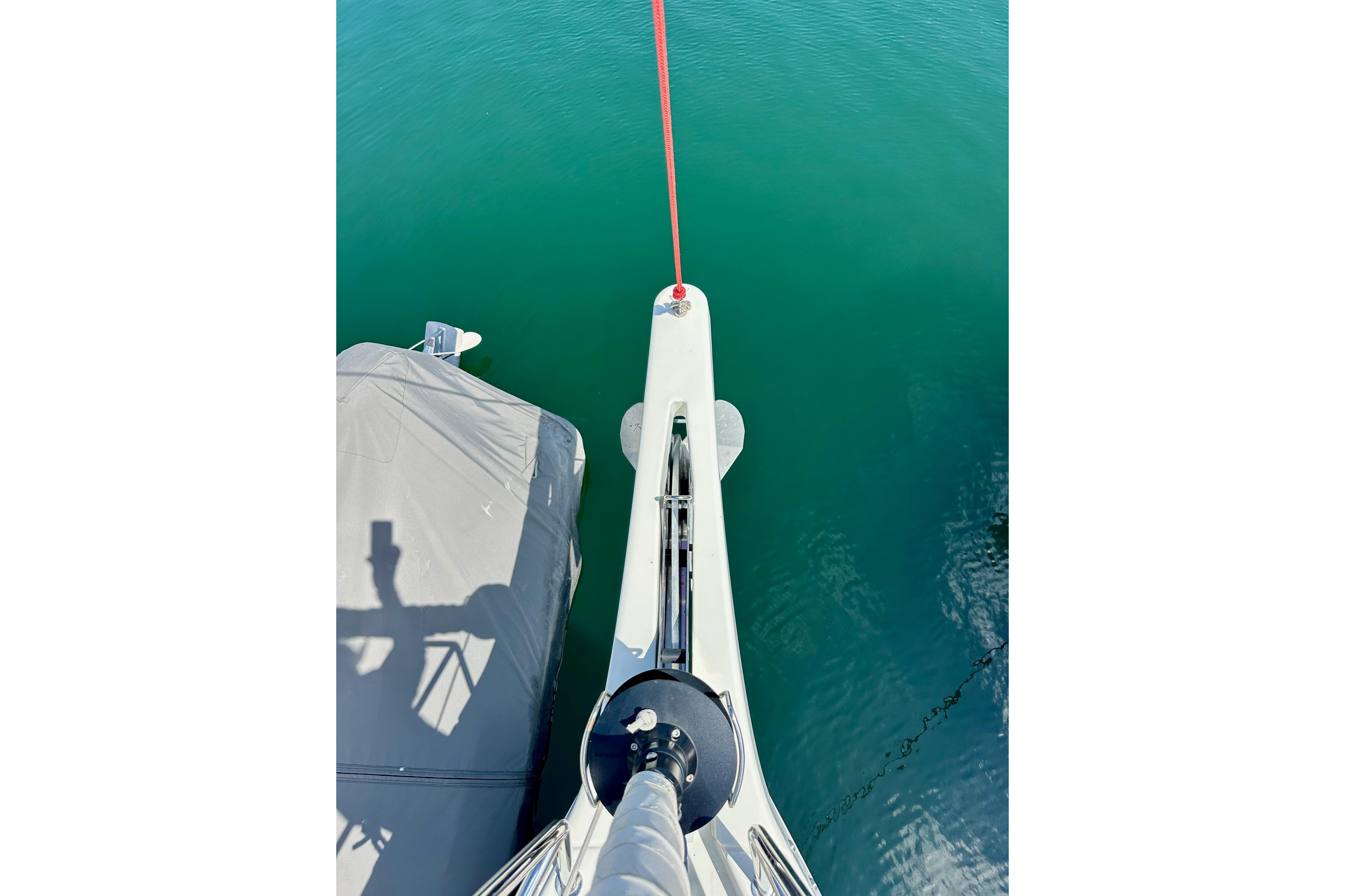 Overhead view of Jeanneau Sun Odyssey 410 yacht bow, 2024 model, on calm water.