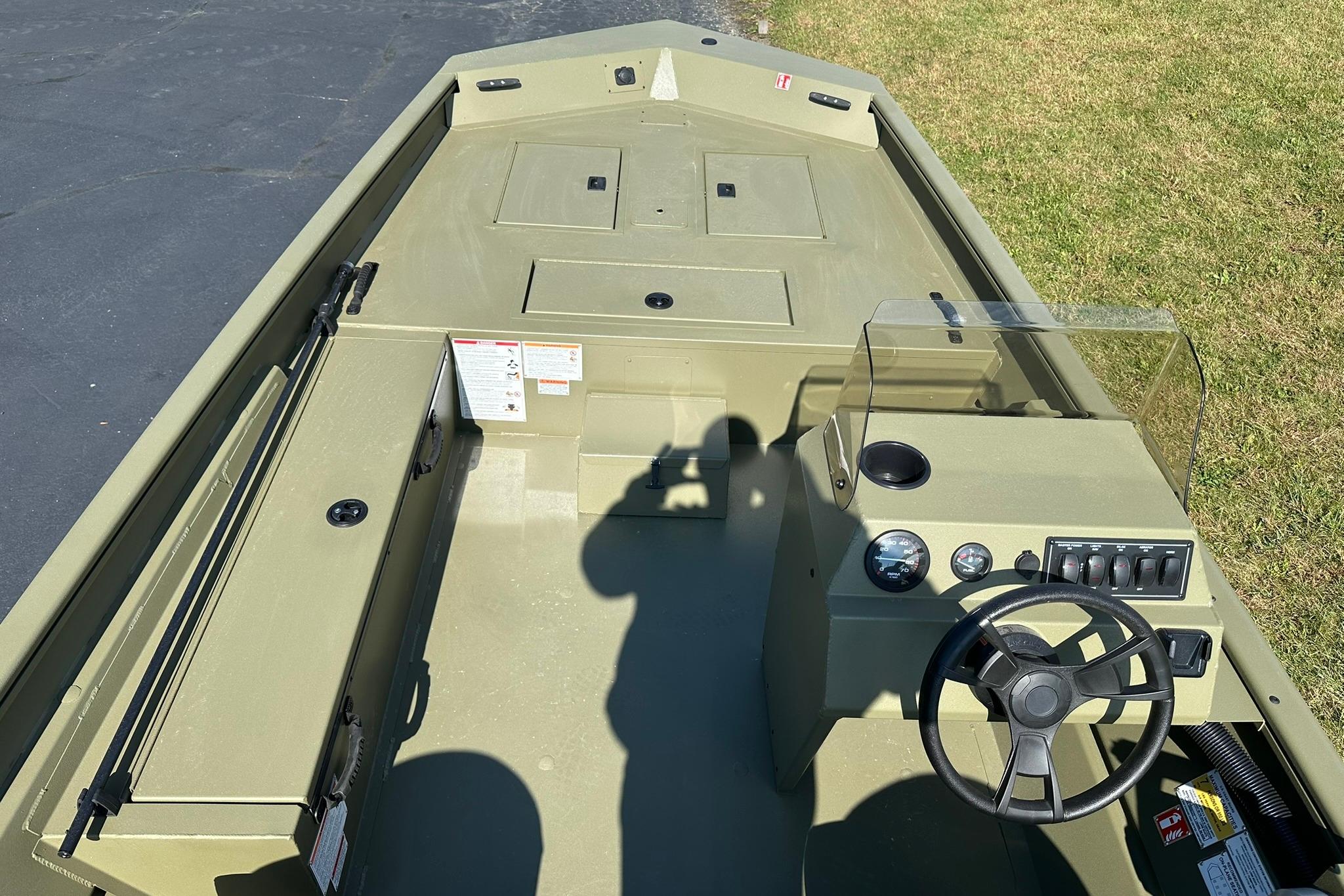 2026 Lowe Roughneck 1860SC boat interior with steering console and storage compartments.