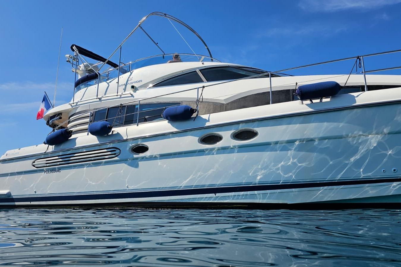 2001 Fairline Squadron 52 yacht on calm water under clear blue sky.