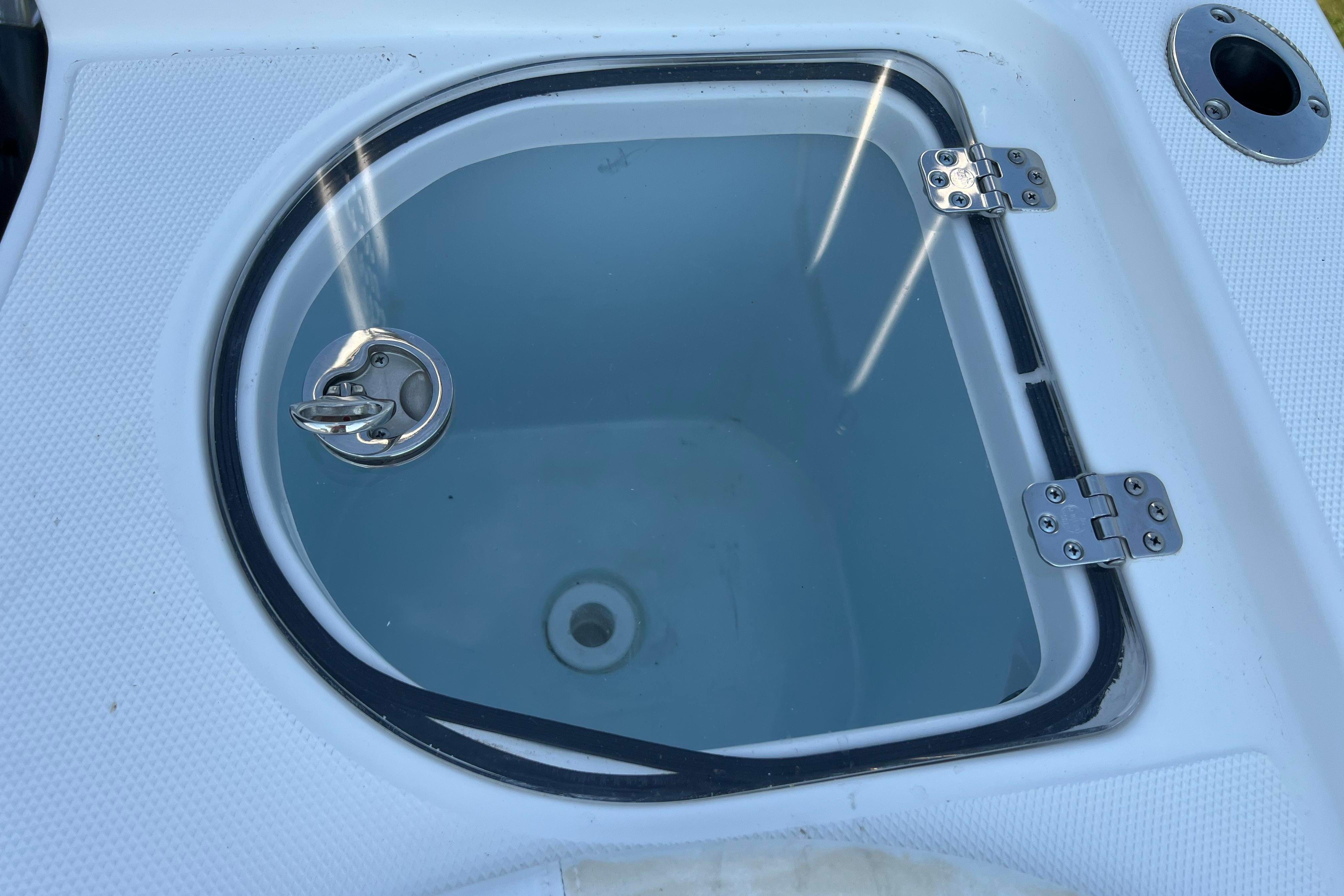 Livewell on 2012 Sea Fox 206 Center Console boat, featuring a secure latch and hinges.