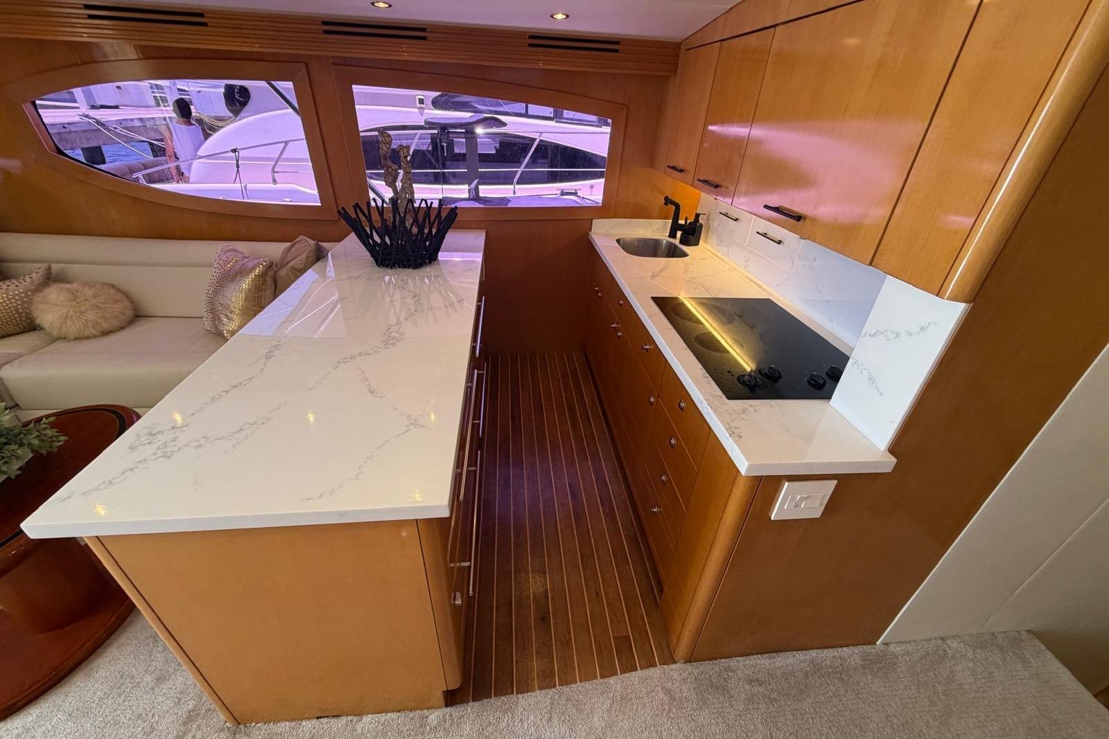 Luxurious kitchen interior of 2003 Hatteras 54 Convertible yacht with modern amenities.