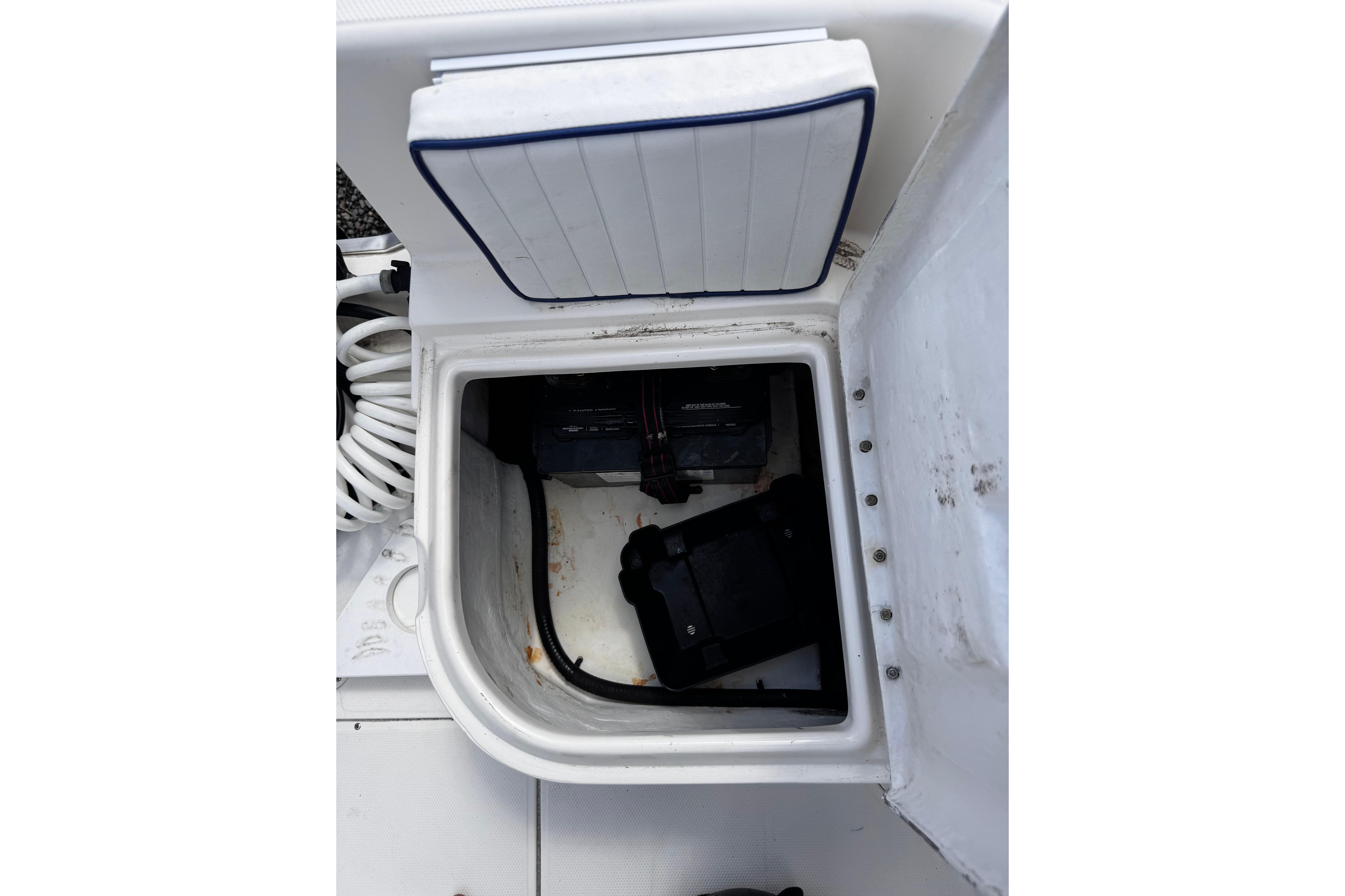 Open storage compartment on a 2003 Palm Beach 2200 Dual Console boat.