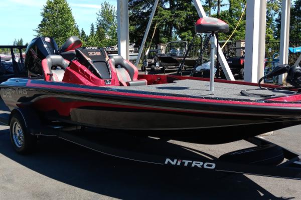 2025 Nitro Z19 boat in red and black, parked outdoors on a trailer.