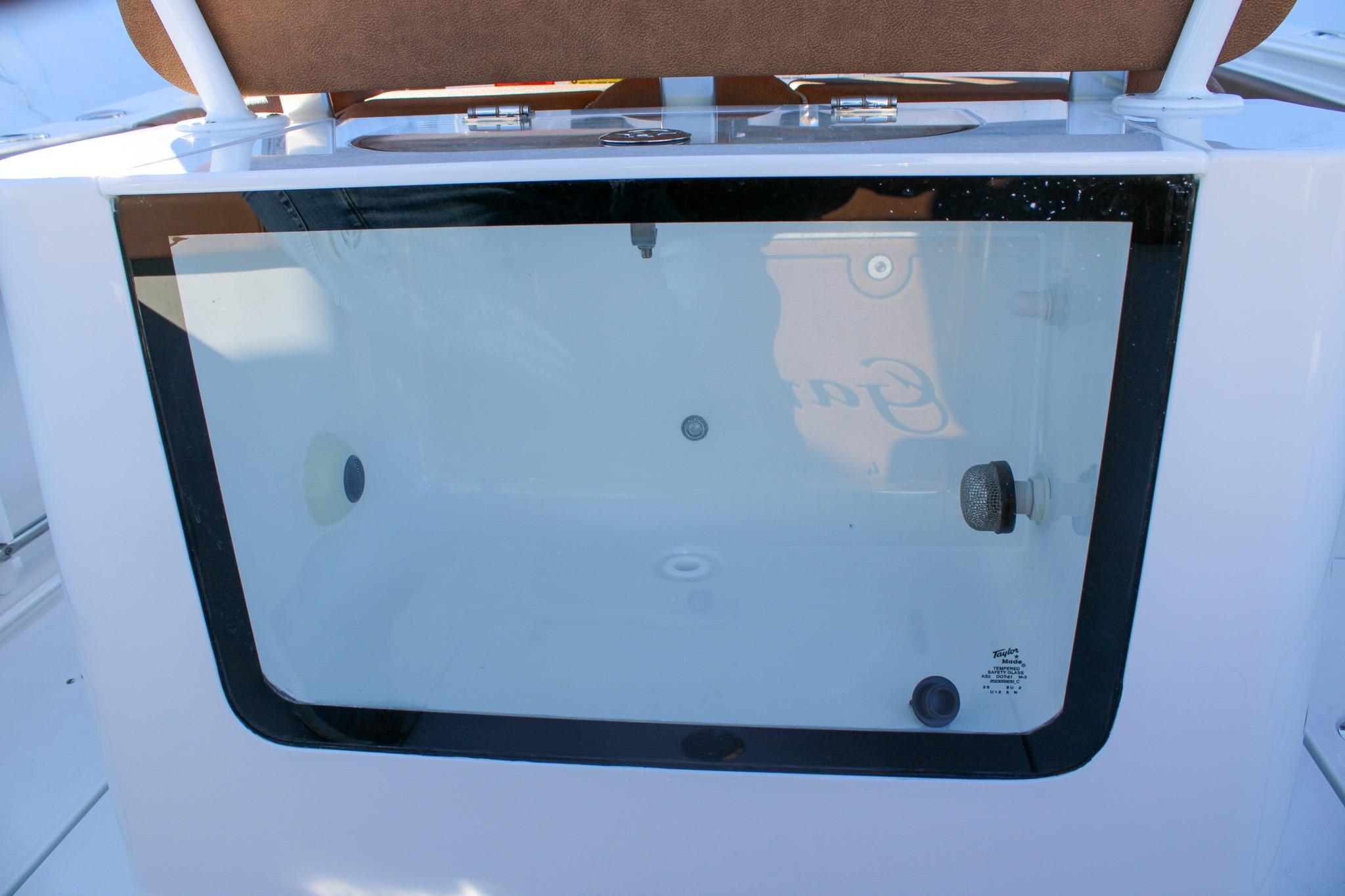 2026 Sea Hunt Gamefish 25 livewell with transparent lid and brown seat.