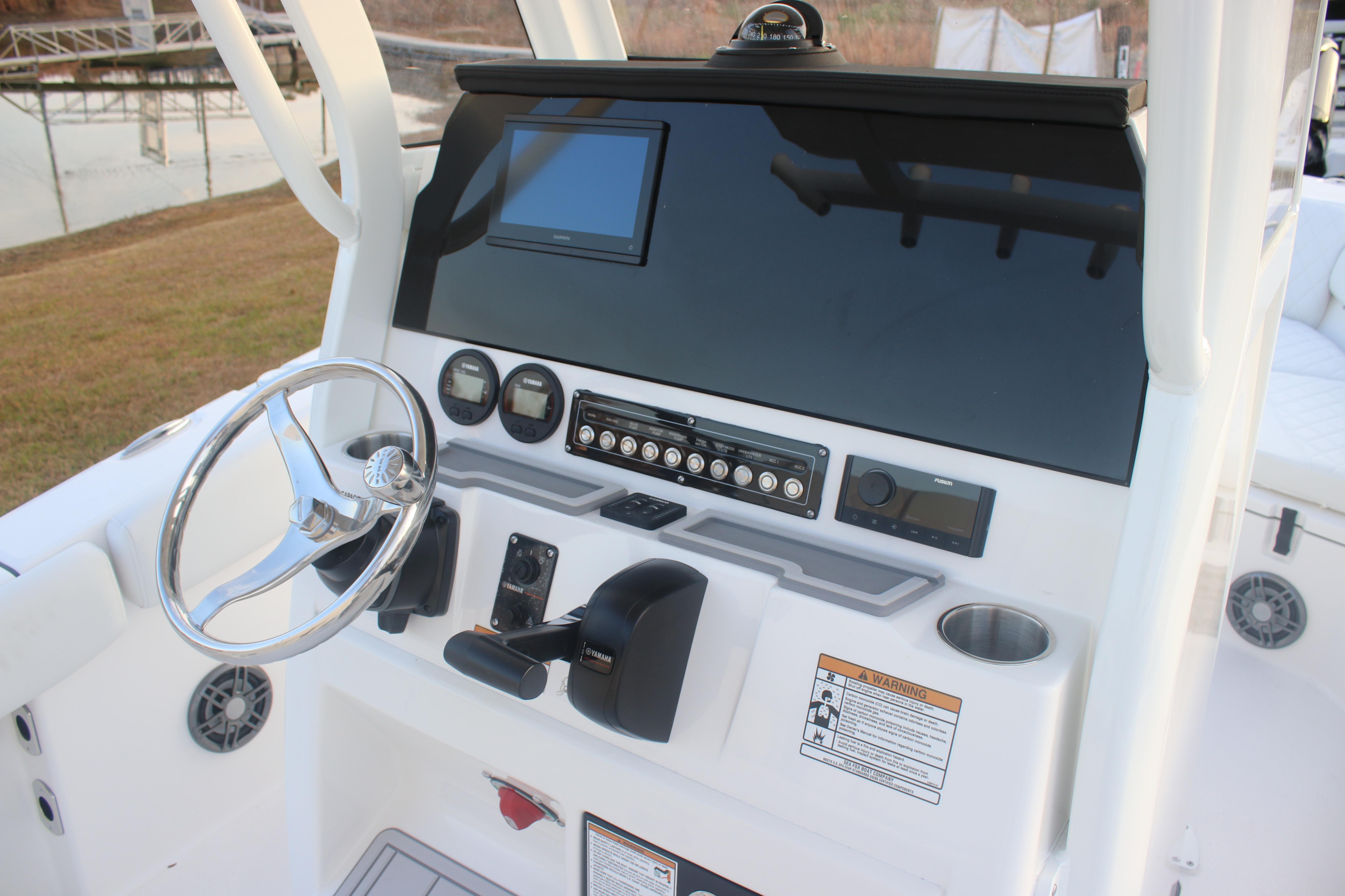 2026 Sea Fox 228 Commander boat dashboard with steering wheel and control panel.