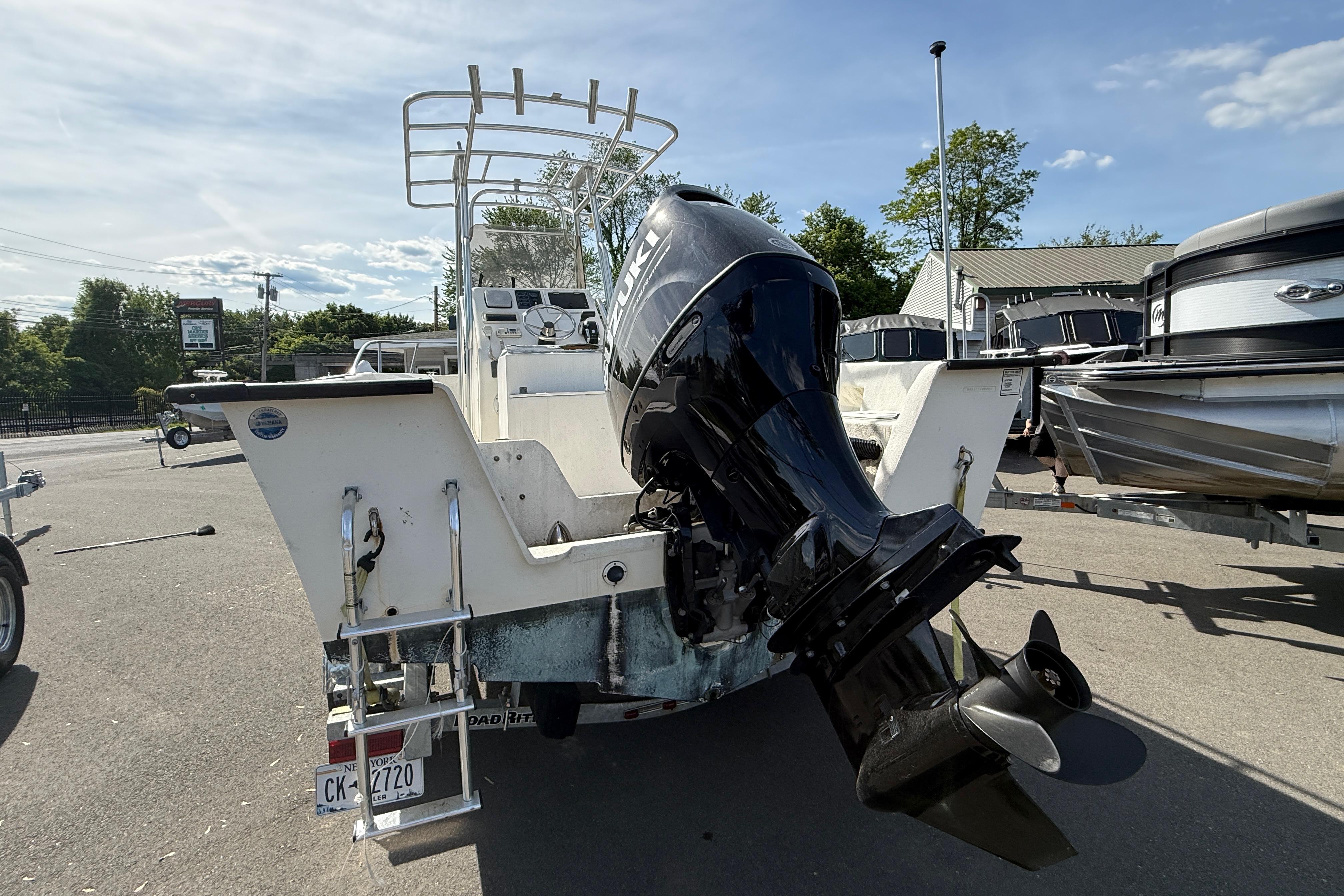 2008 Key Largo 206 Center Console boat with outboard motor in a marina setting.