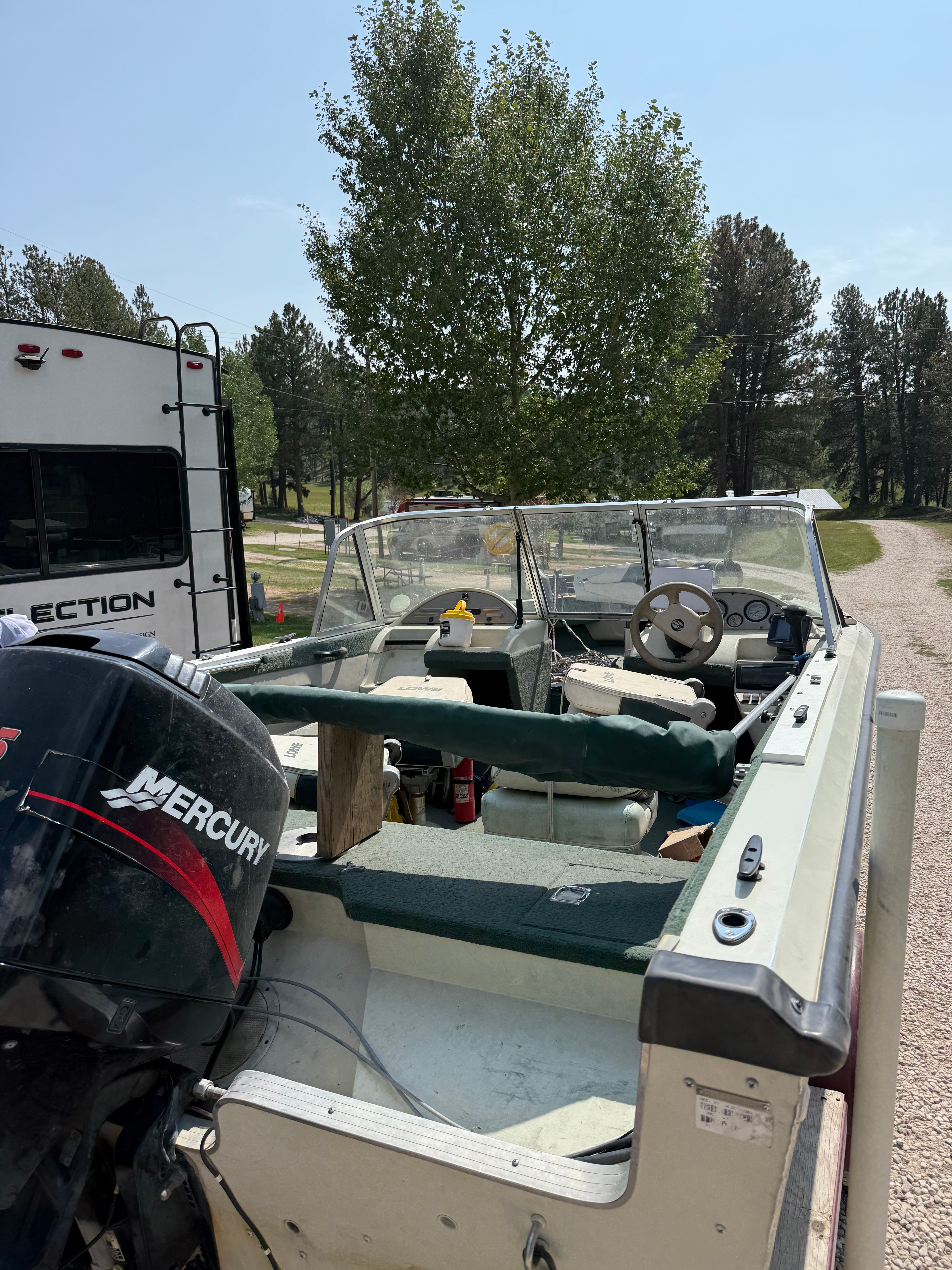 1999 Lowe Roughneck boat with Mercury engine on a trailer.