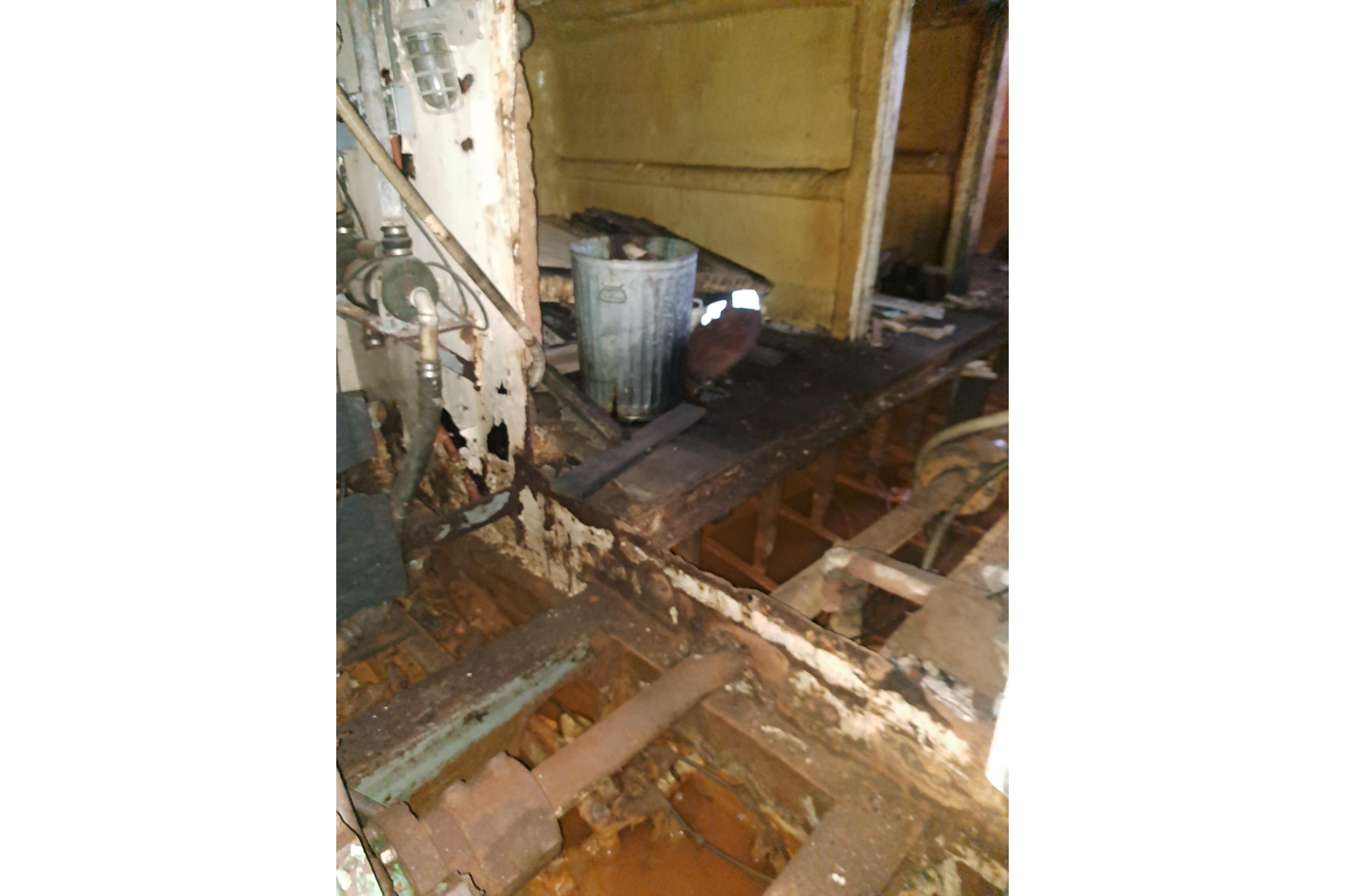 Interior of a 1979 Custom Steel Trawler Dragger, showing rust and structural wear.