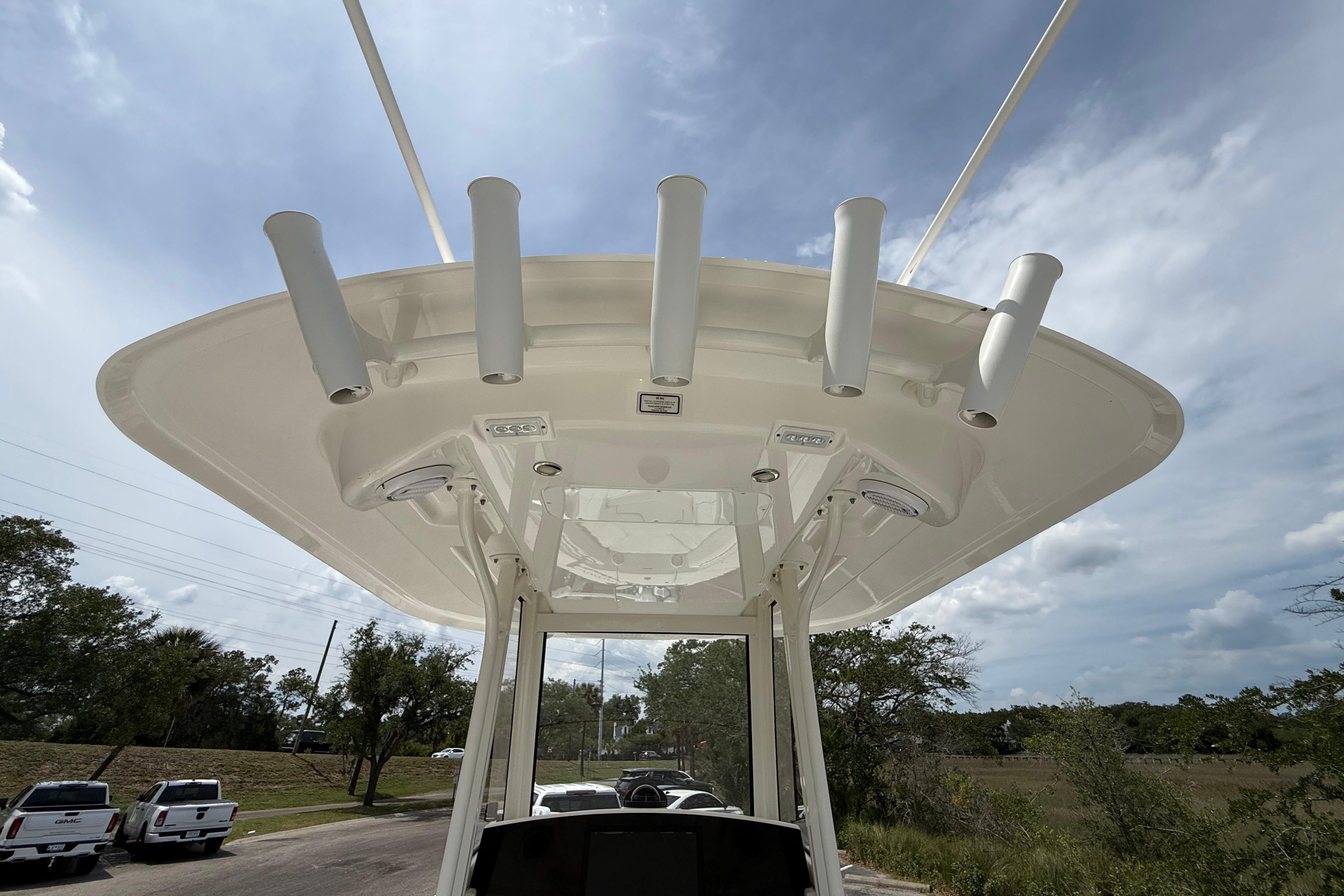 2019 Regulator 26XO boat top view with rod holders under a clear sky.