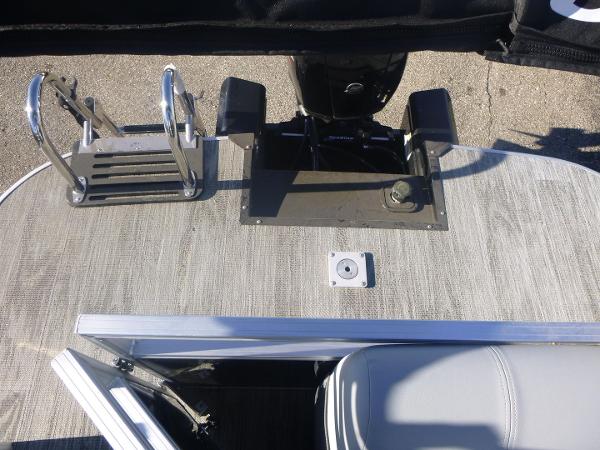 2024 Ranger Reata 223C boat deck with motor and ladder.