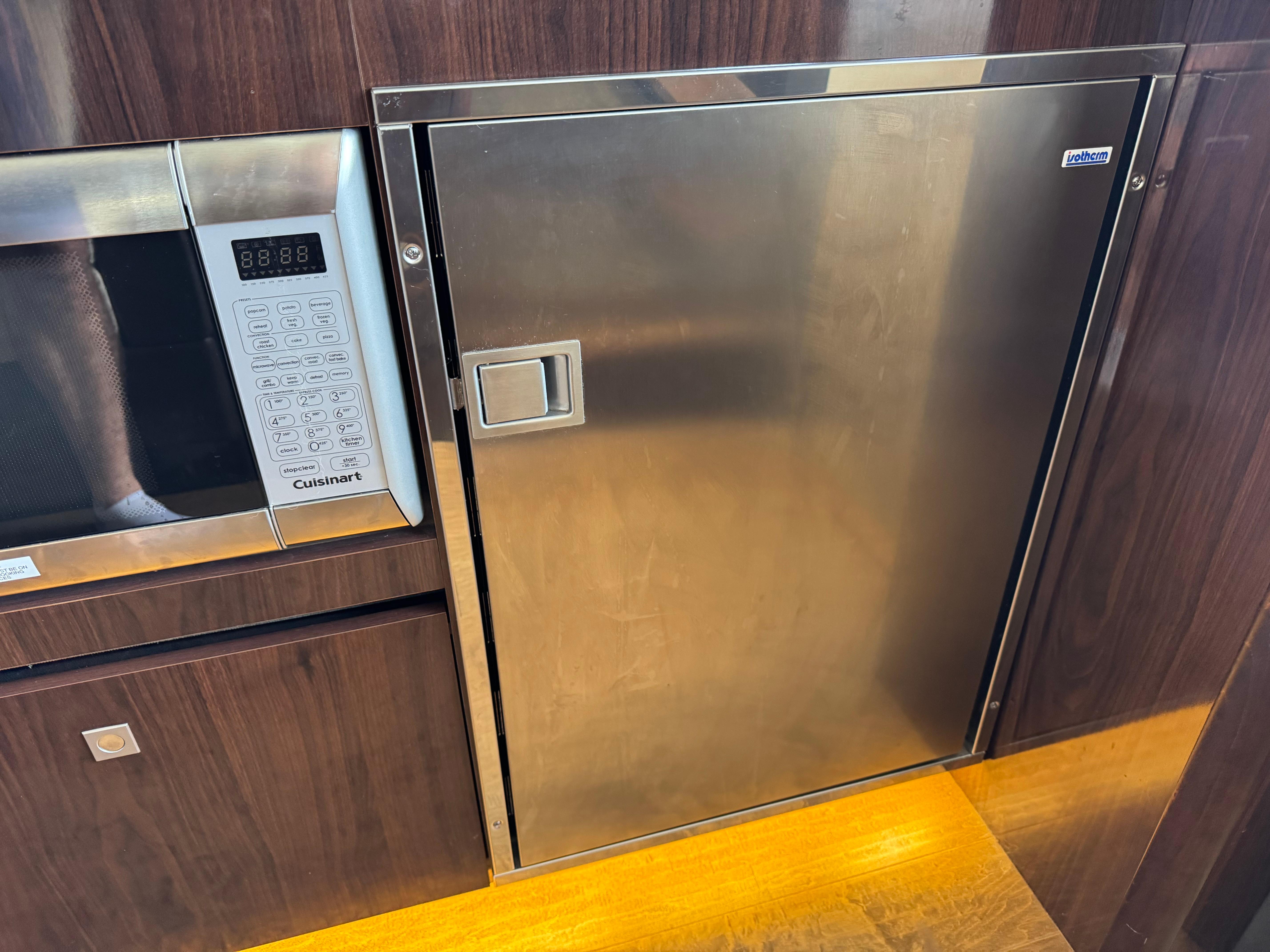 2017 Sea Ray Sundancer 400 kitchen with stainless steel fridge and Cuisinart microwave.