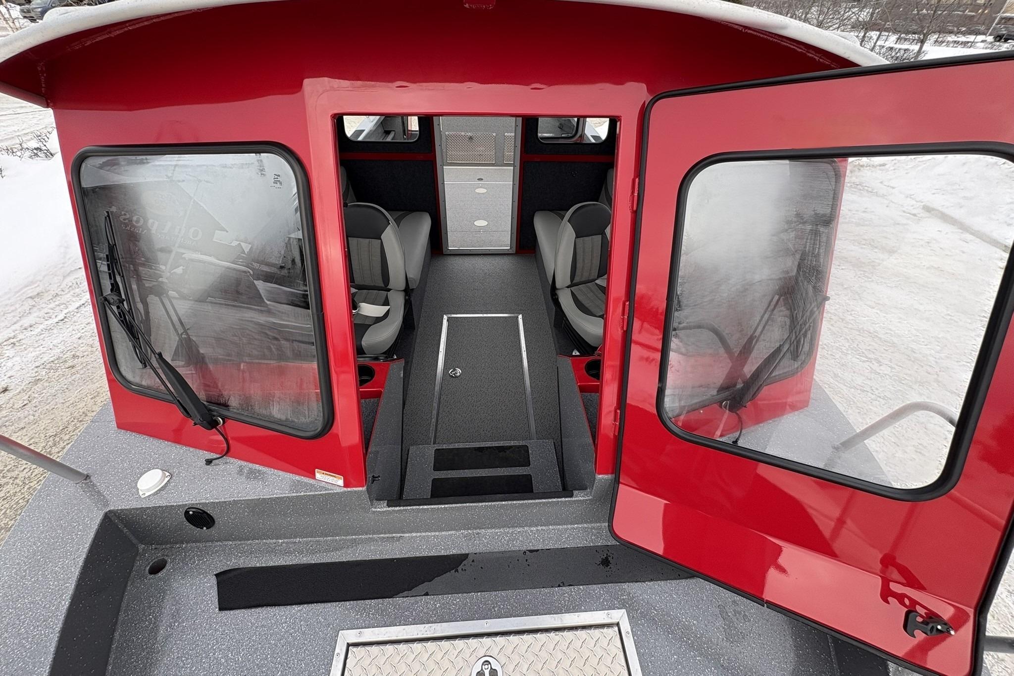 Red 2024 Spartan 240 Maximus Pro boat interior with open doors and seating.